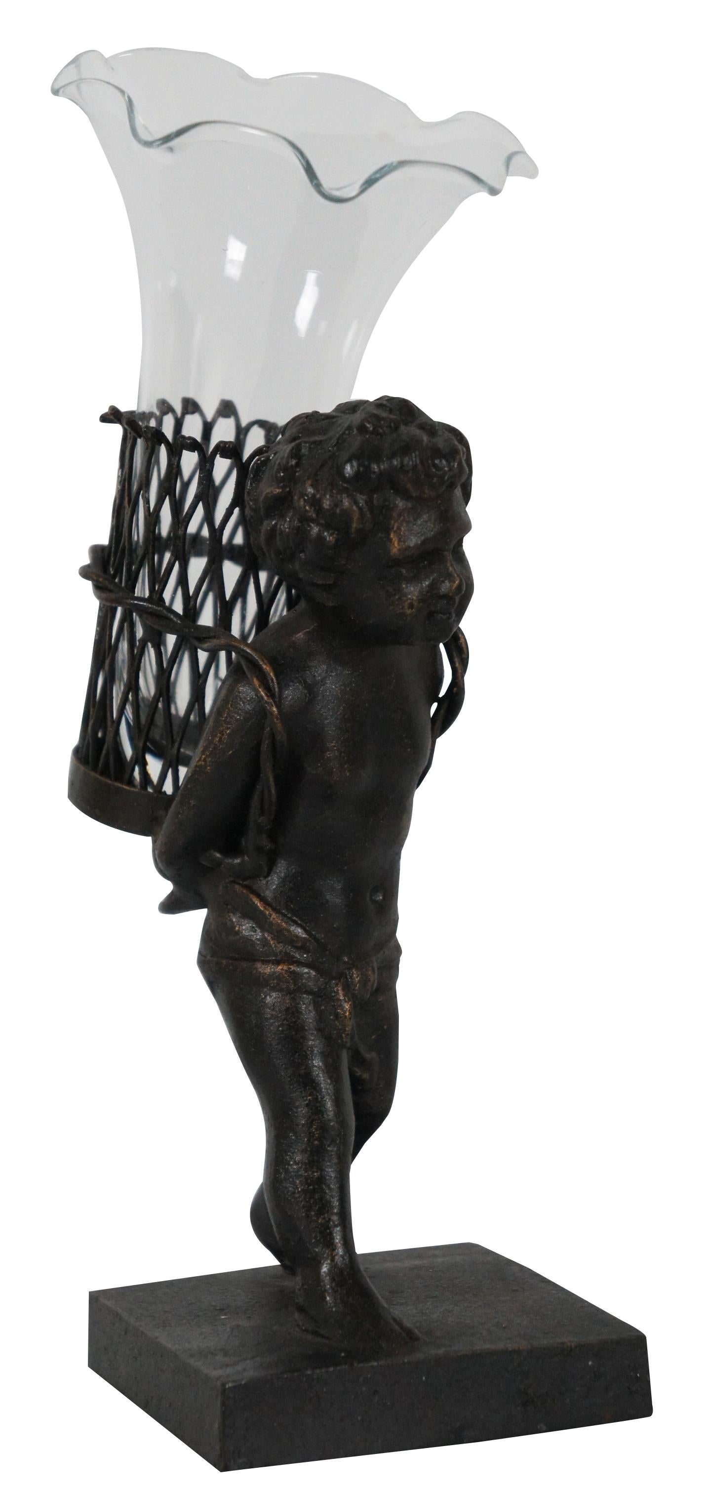 Contemporary bronze figurine of a child walking with a basket containing a ruffled edge glass bud vase.
 