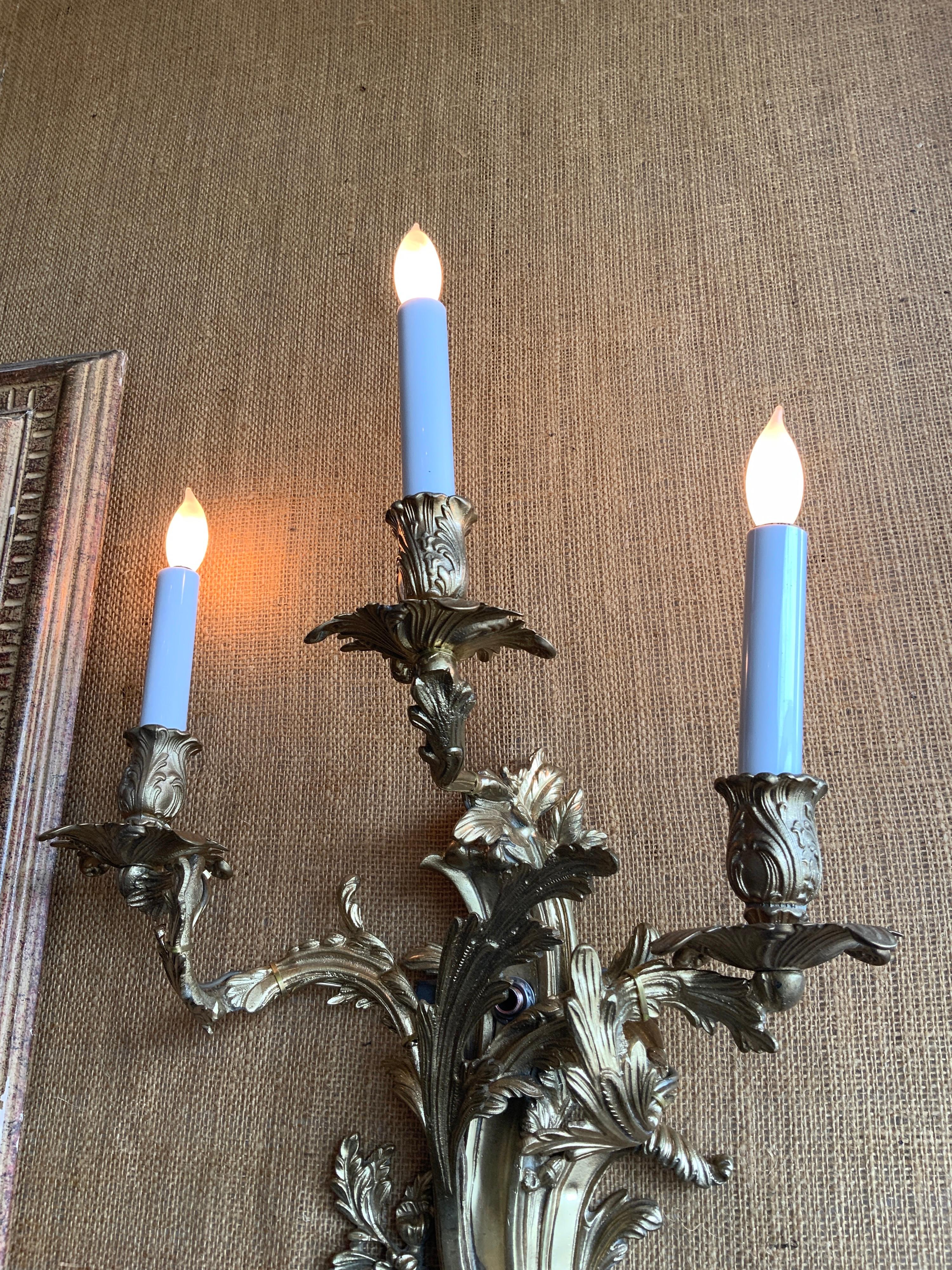 This pair of bronze sconces originates in France, circa 1910.