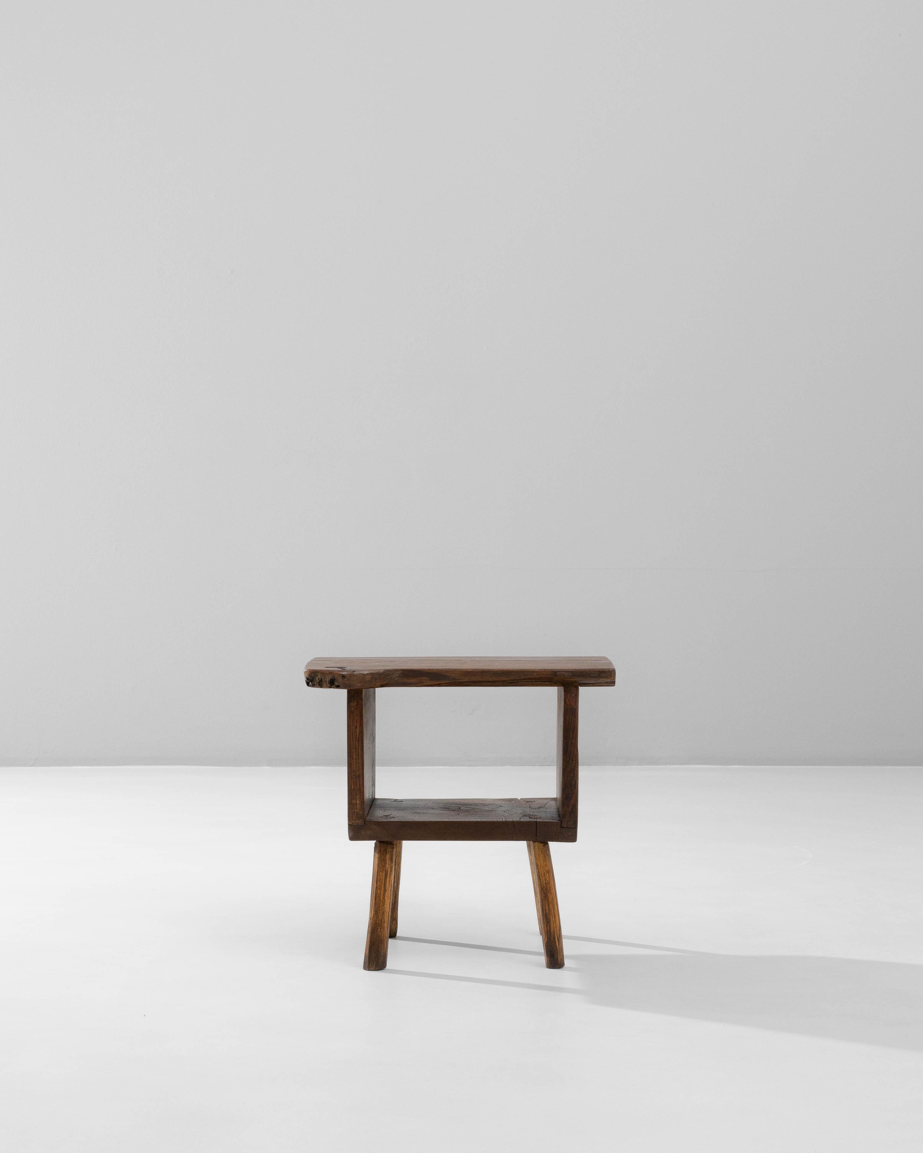 20th Century French Brutalist Wooden Side Table. This sculptural side table exemplifies the raw, handcrafted aesthetic of Brutalist design, characterized by its bold form and emphasis on natural materials. Crafted from solid wood, it features an