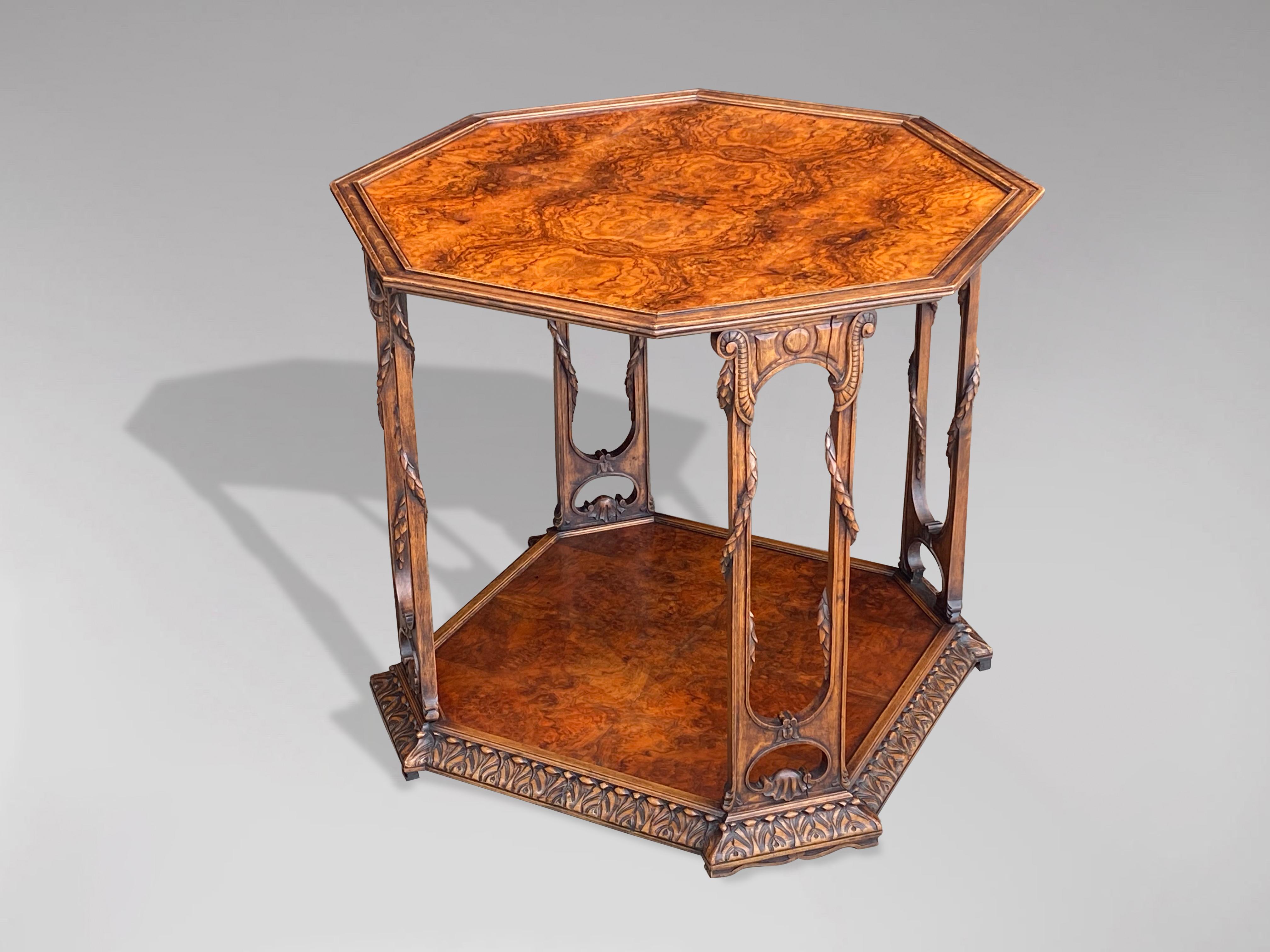 A fine 20th century large octagonal burr walnut two tier end table. The dished moulded burr walnut veneer tray top with four open carved upright supports, on carved and moulded conforming base.

The dimensions are:
Height: 67cm (26.4in)
Width: