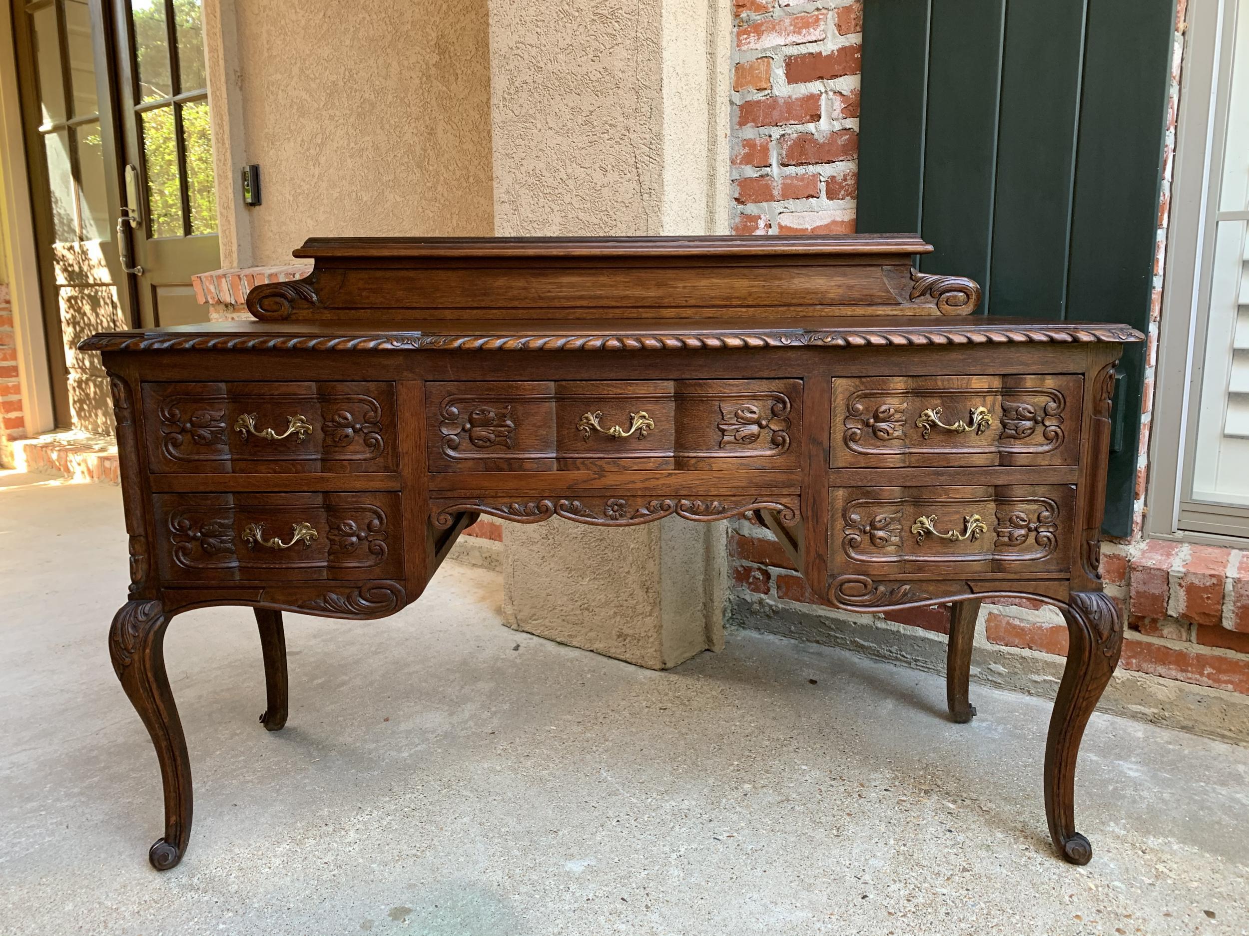 ~Direct from France ~
~Lovely and large, this antique French carved oak desk will add French style to any room!~
~Quintessential French Louis XV style~
~Large desk top has a serpentine edge, beveled and carved, that provides abundant room for