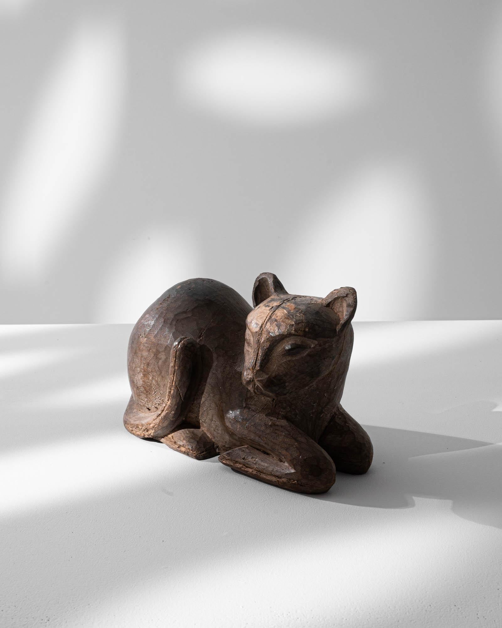 Embrace the regal allure of this 20th-century French Carved Wooden Cat Decoration, portraying the elegance of a Sphinx cat. Crafted with precision and artistic finesse, this little feline exudes a sense of grace and sophistication. The smooth lines