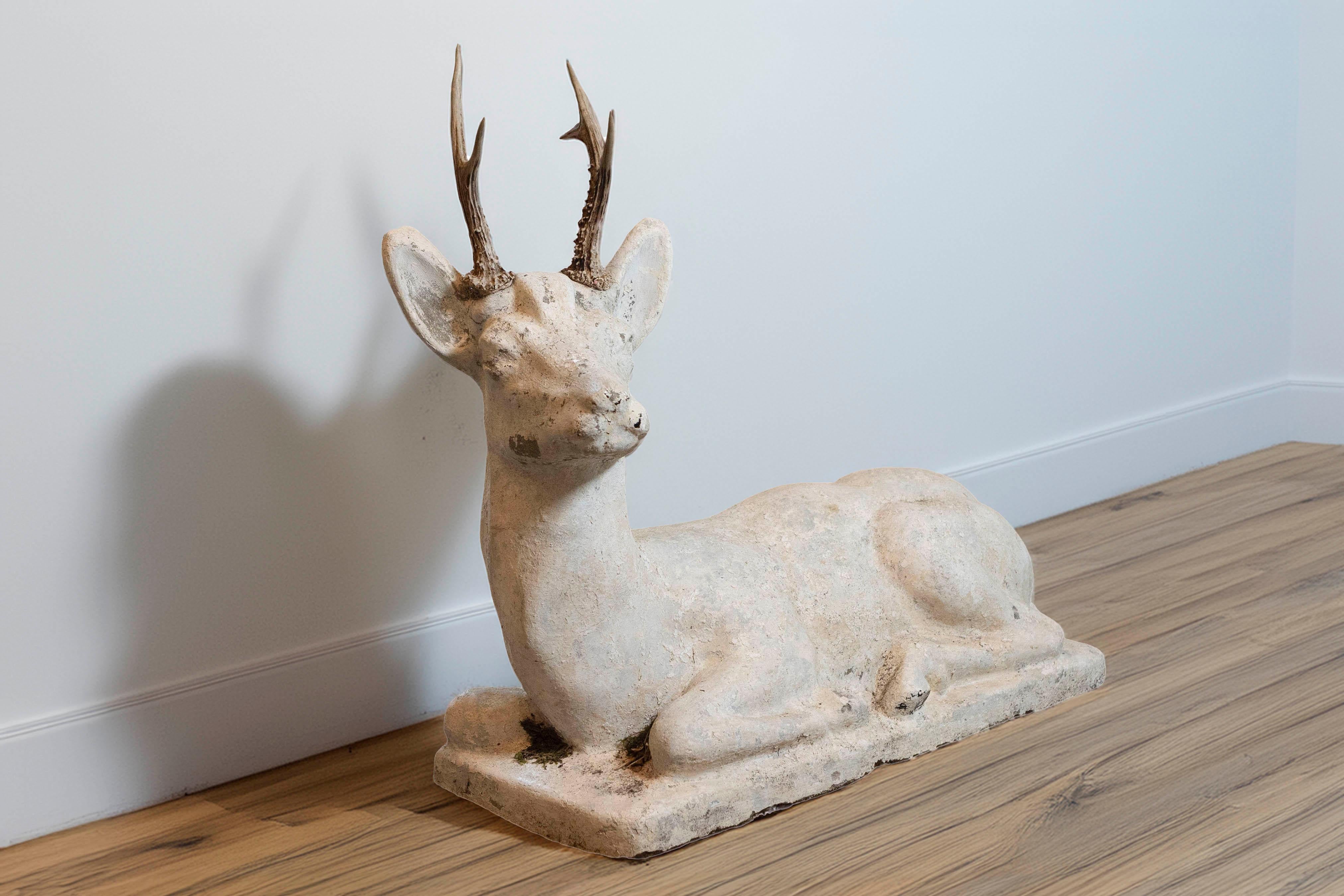 This 20th-century French cement deer sculpture embodies rustic charm and naturalistic elegance, making it a versatile decorative piece for both indoor and outdoor settings. Skillfully crafted from durable cement, the sculpture captures the serene