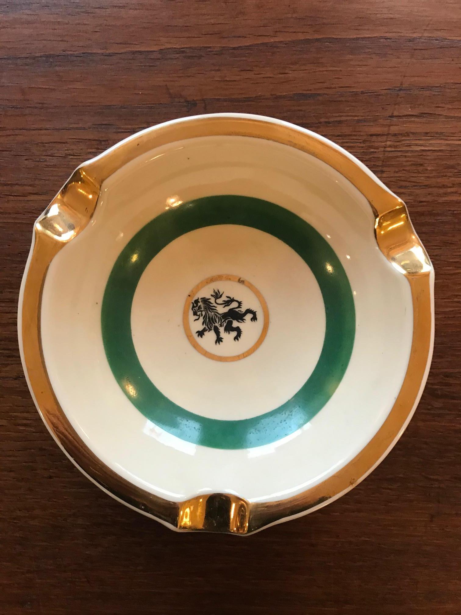 Very nice 20th century French ceramic ashtray from the 1950s. Green and gold color. 
A lion is designed in the center of the ashtray because it's the symbol of the city of Lyon (South east of France).
It was a gift from a French (Lyon) bank to its