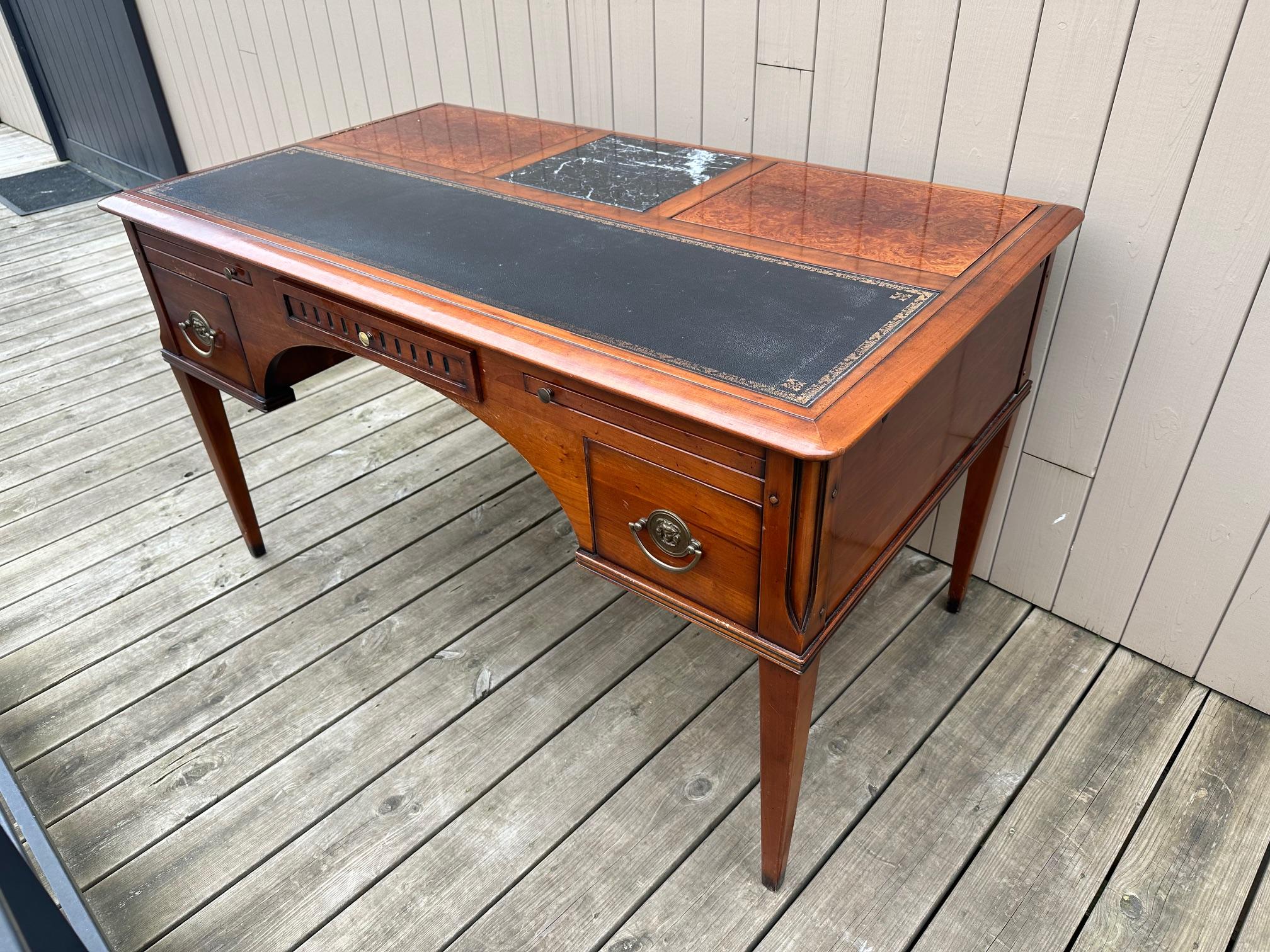 Very beautiful system desk from the 80s in cherry wood.
Leather top, one zipper on each side and two zippers at the front. 
Two easels that fold on either side of a marble top.
A central drawer as well as two drawers on the sides. Brass handles.