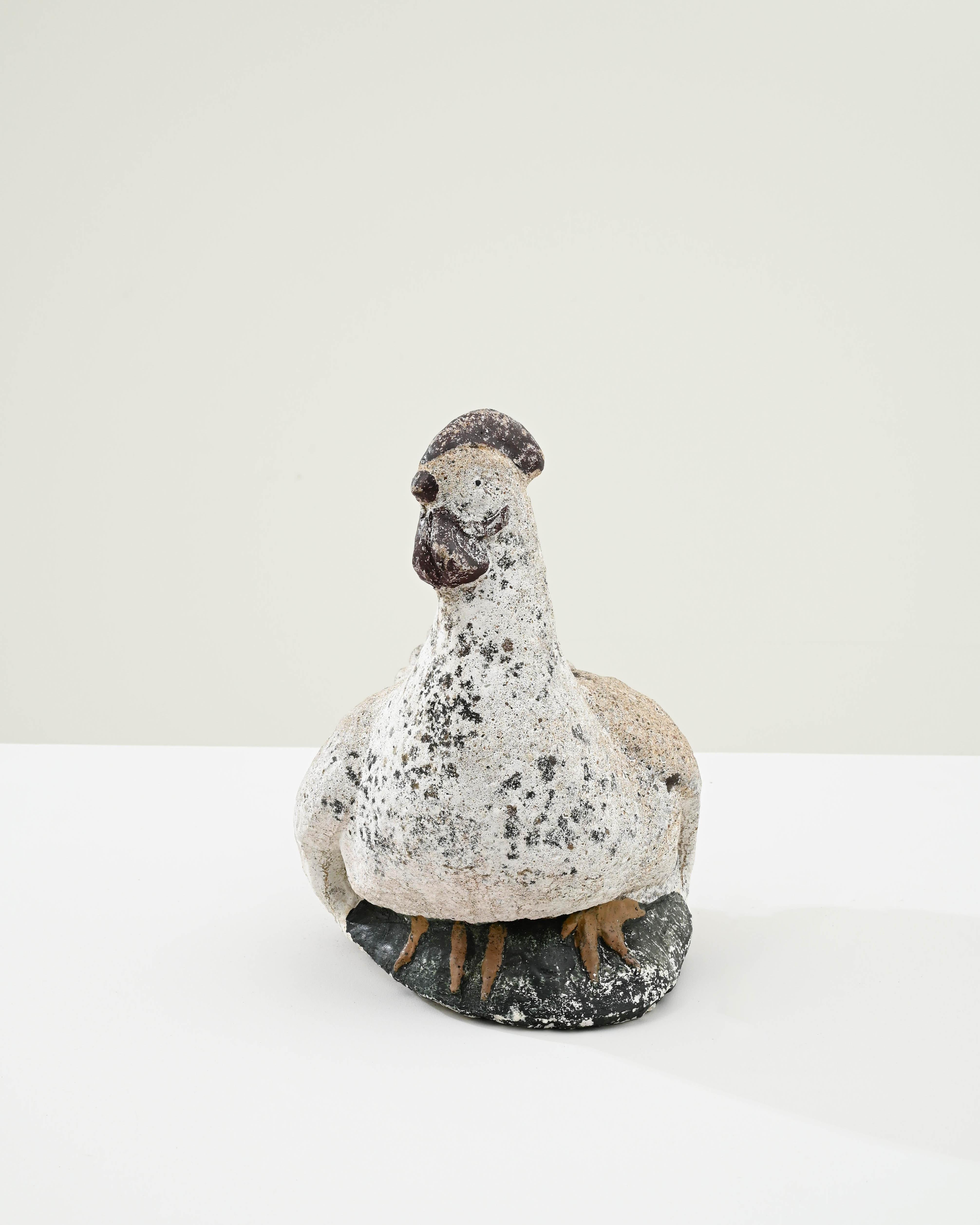Capture the rustic essence of French country living with this charming 20th Century French Chicken Concrete Sculpture. This delightful piece, with its textural finish and lifelike poise, brings a touch of pastoral elegance to any space. Crafted with
