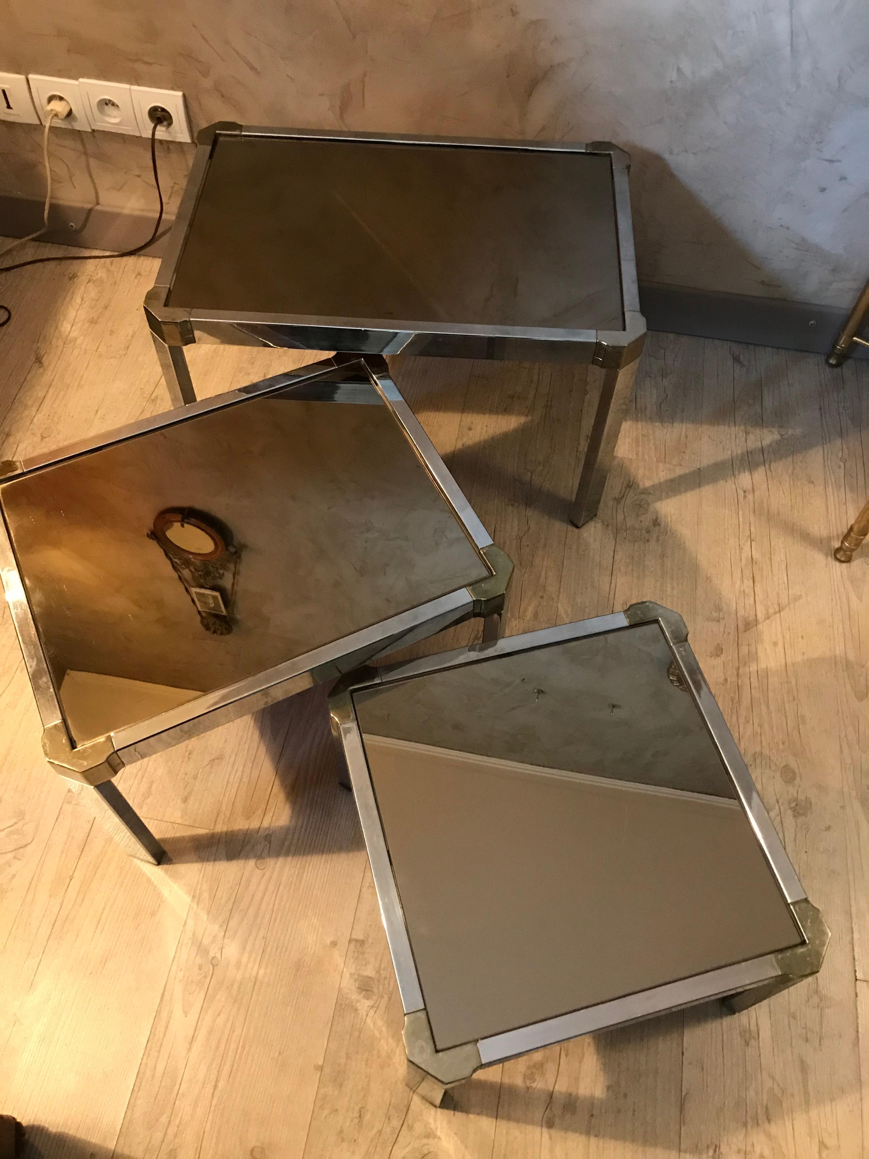 Beautiful 20th century French chromed metal and mirror nesting tables from the 1950s. 
The three mirror tops are removable. 
Good quality.
 