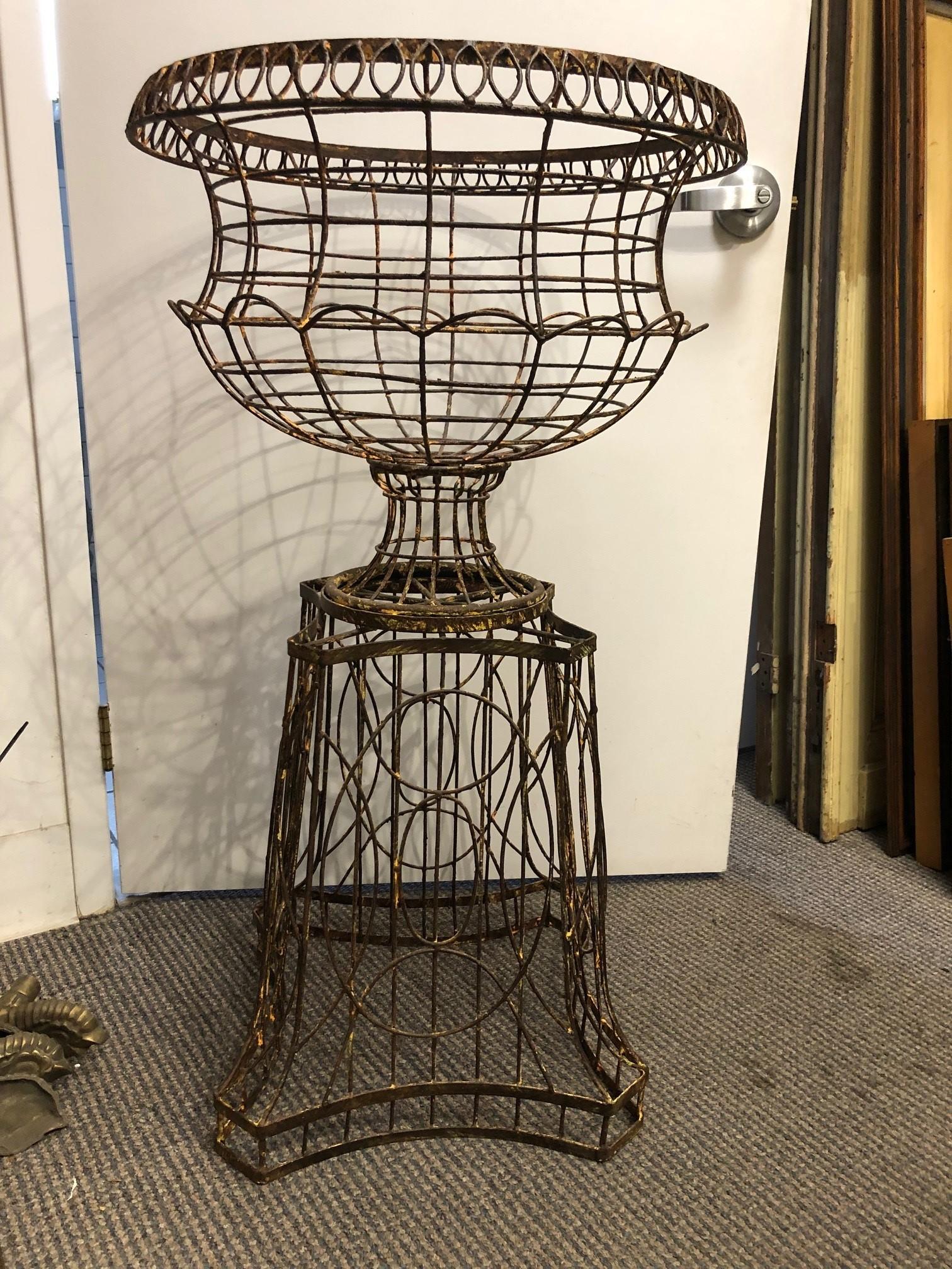 20th century French Classical style wire urn on a pedestal base featuring a rustic painted finish from a Westport CT. estate.