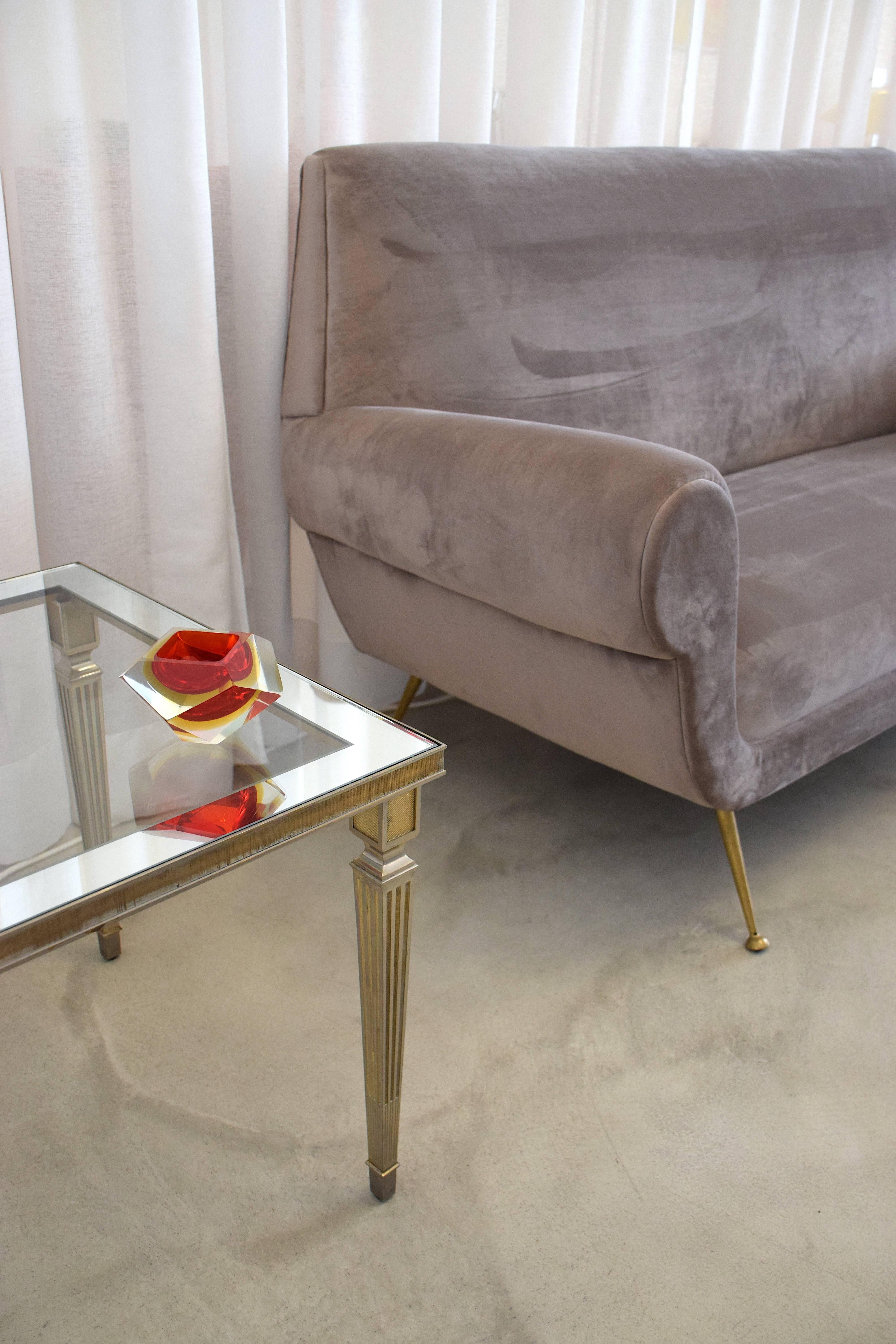 A 20th century vintage Maison Jansen coffee or side table in neoclassical style composed of a silver plated brass structure with fluted legs and intricate perforated details.

France, 1970's. 