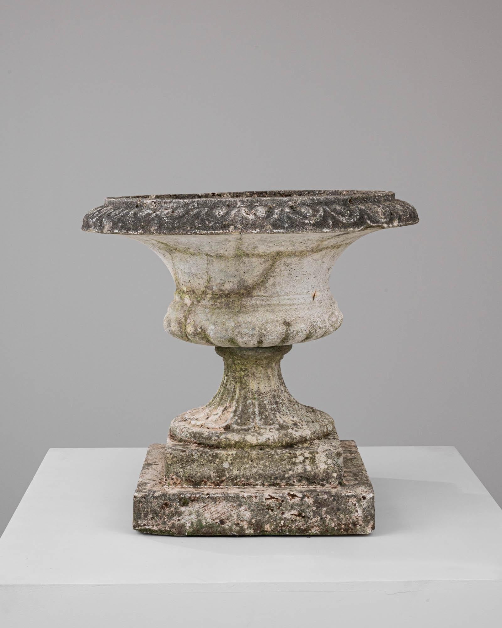 This 20th-century French concrete planter stands as a sculptural tribute to the art of classic garden design. Its wide, welcoming brim and stout base are characteristic of traditional European elegance, lending a stately presence to any setting. The