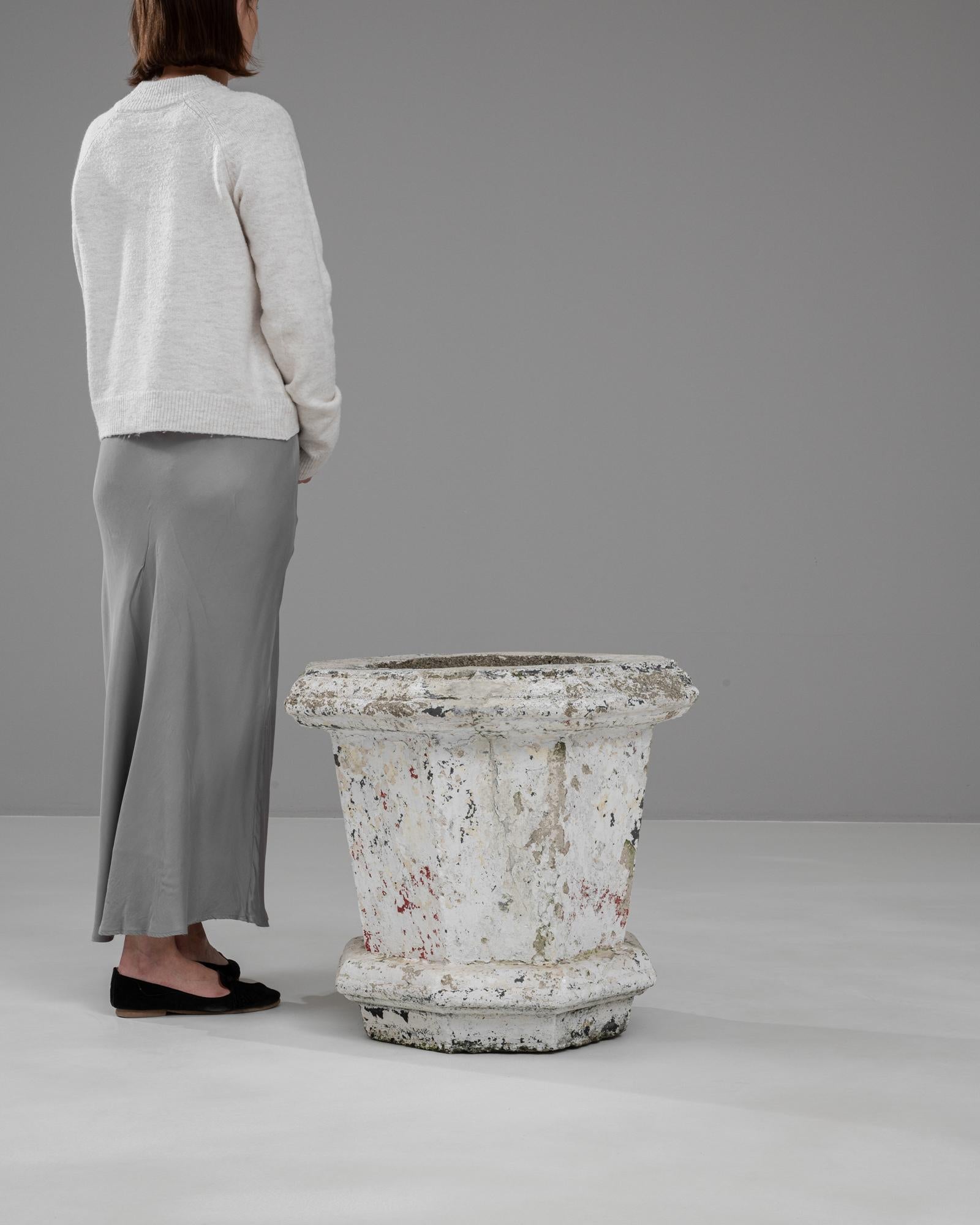 Infuse your space with the historical elegance of this 20th Century French Concrete Planter. Boasting a distinctive splattered paint finish on its robust concrete structure, this planter encapsulates the charm and character of vintage decor. The
