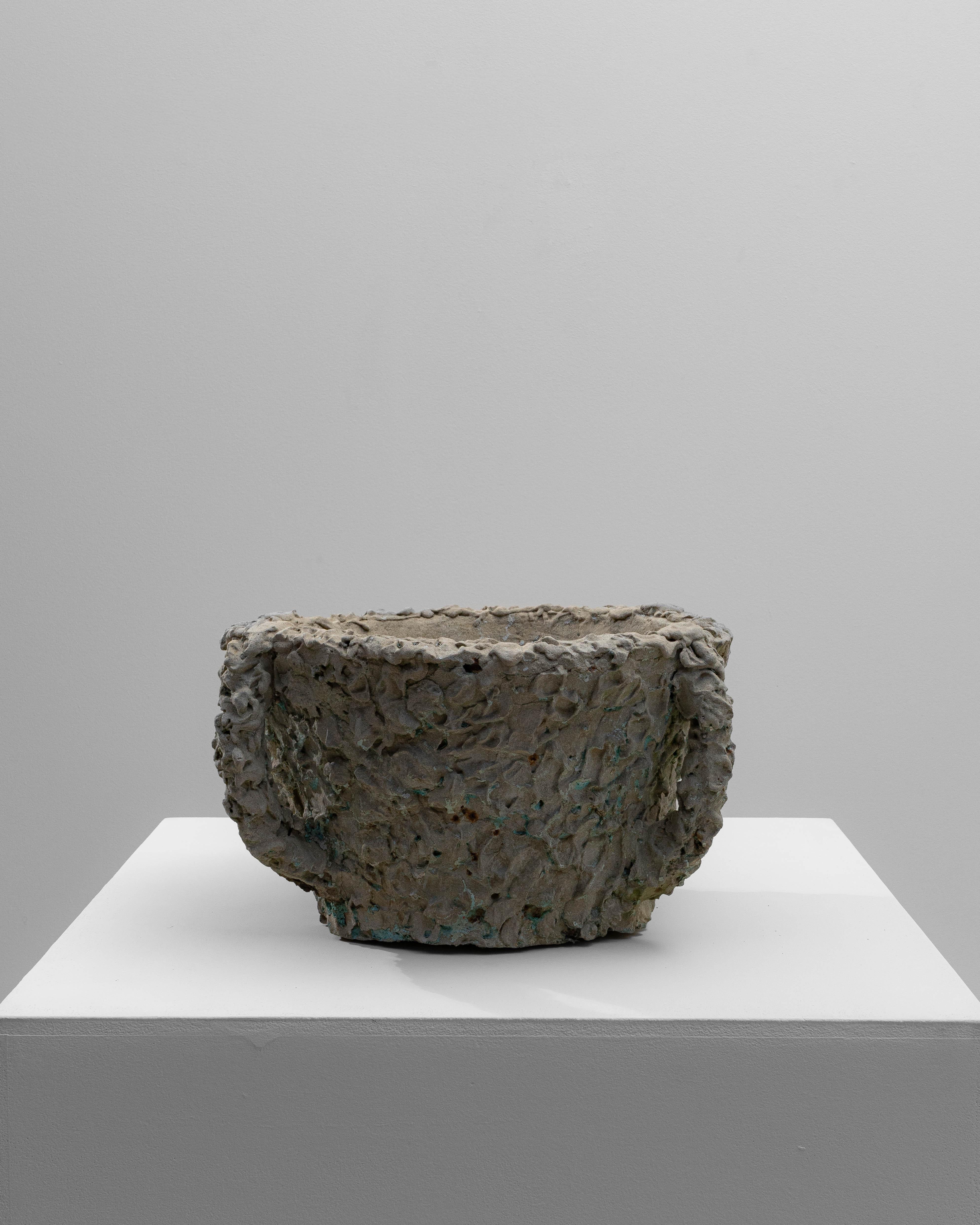 20th Century French Concrete Planter. This sculptural French planter from the early to mid-20th century features a richly textured concrete surface that evokes an organic, almost hand-formed quality. Its irregular, tactile exterior is accented by