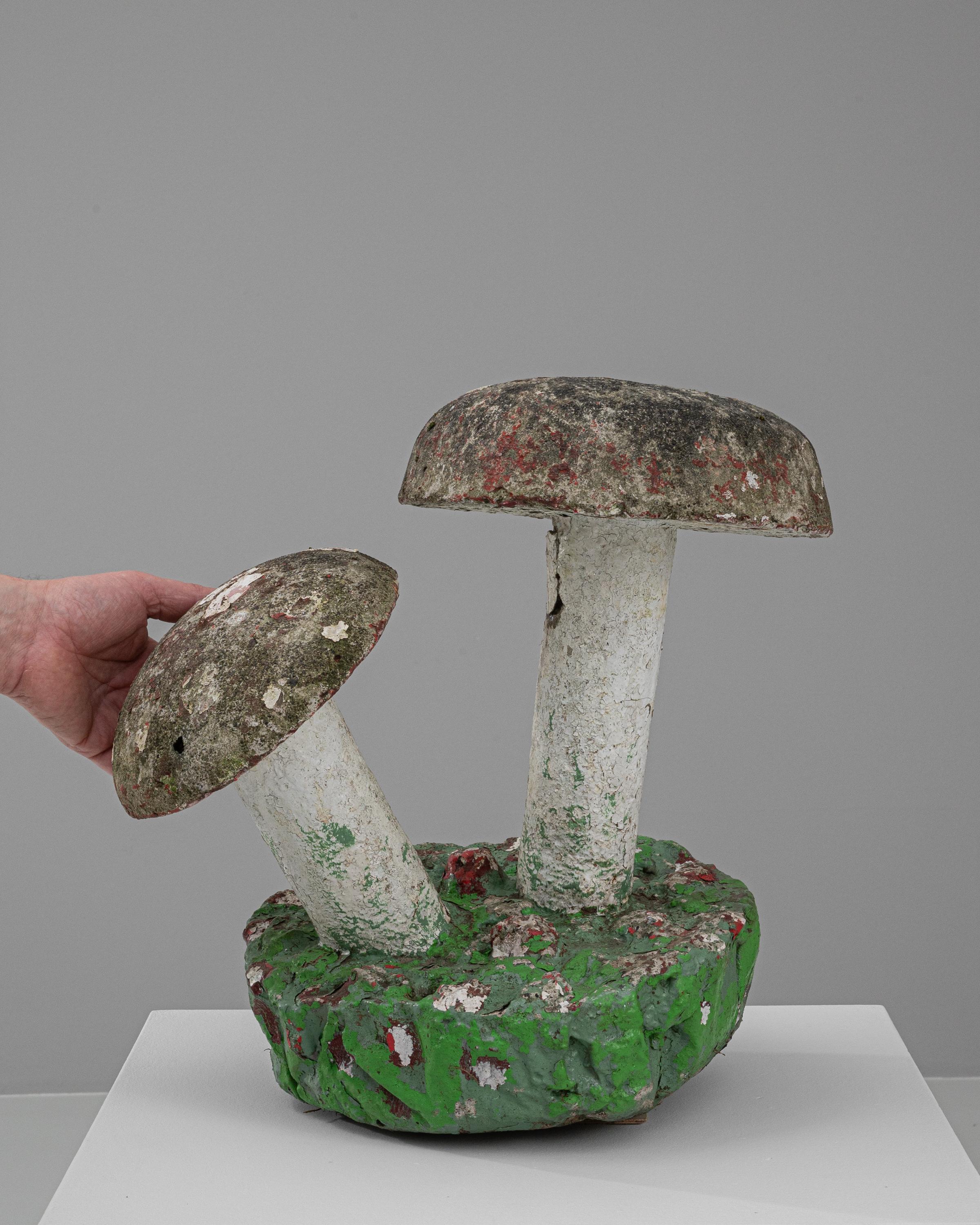 Bring a whimsical flair to your garden or patio with this charming 20th Century French concrete sculpture, depicting a duo of rustic mushrooms. This enchanting piece captures the essence of a fairy tale forest with its earthy tones and mossy green
