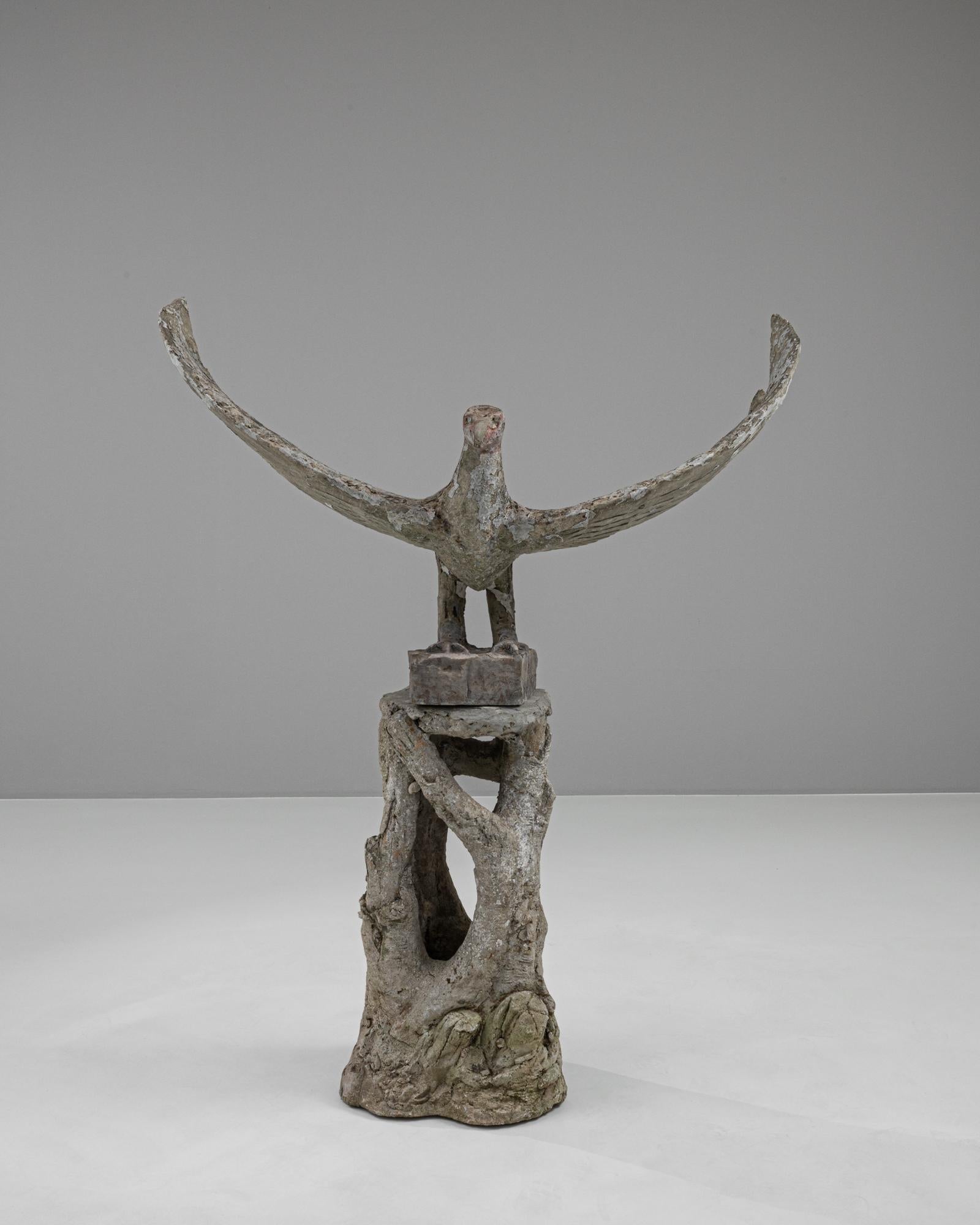 This striking 20th Century French Concrete Sculpture captures the raw, emotive power of natural forms, melded with abstract artistry. Shaped to resemble an bird in mid-flight, this piece embodies a dynamic sense of movement and grace. Perched atop a