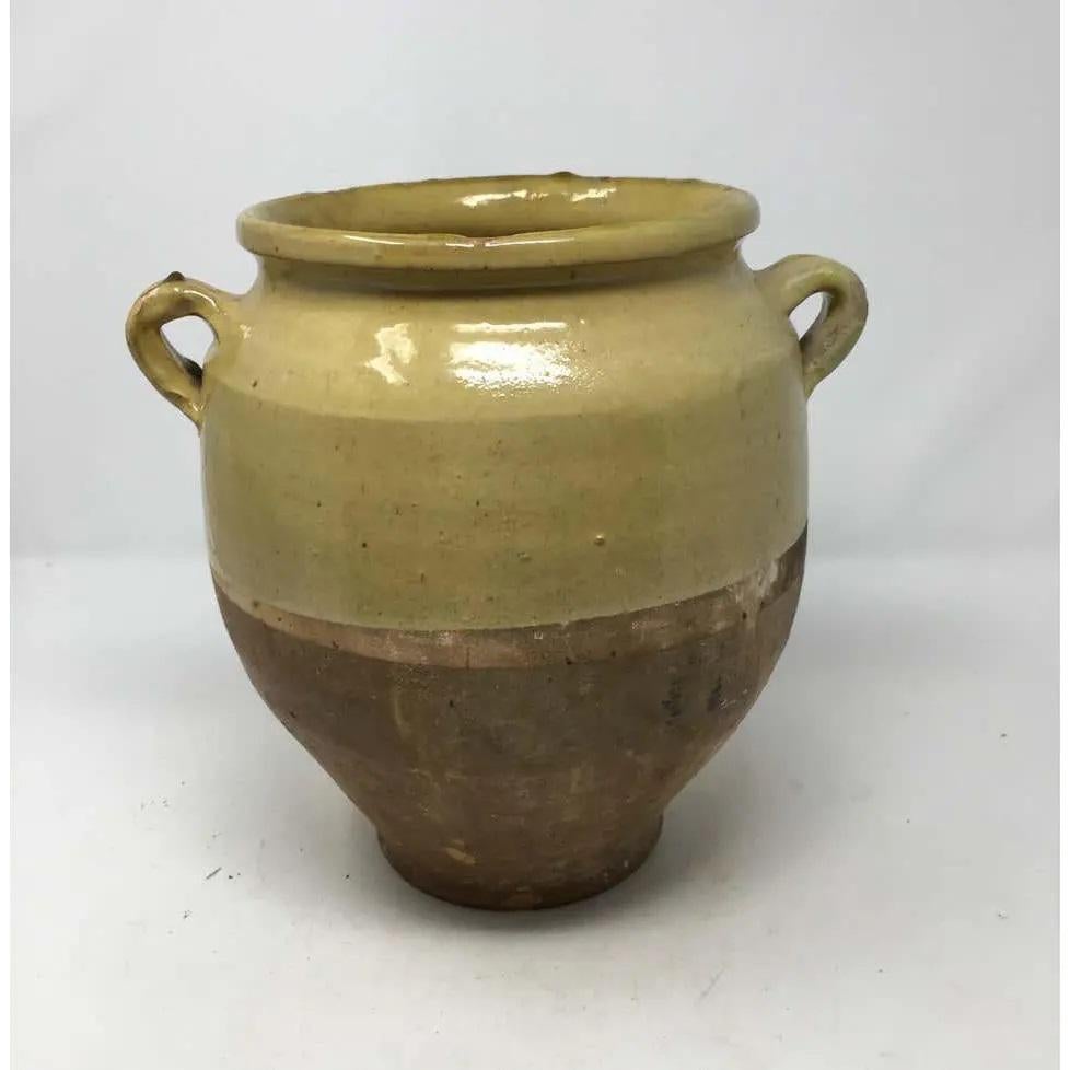 Found in the South of France, this is a lovely French confit pot. Confit pots were used for food preservation. The bottom half was left unglazed to allow the pot to keep cool while half buried in the ground. Featuring a wonderful glazed color this