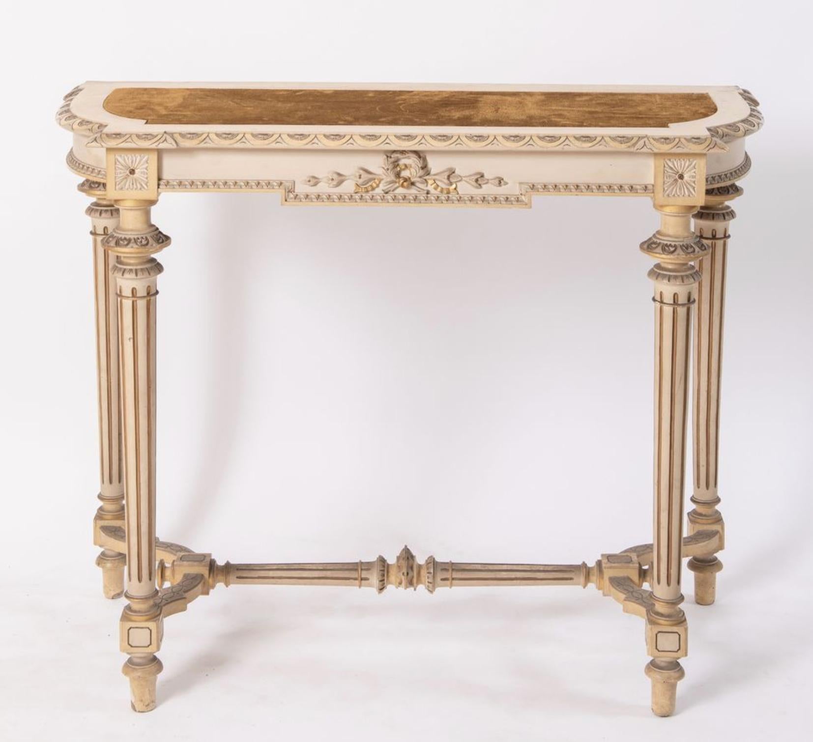 French wooden hand painted console table with cognac velvet top. The table is hand carved with typical details for Louise XVI style like the gilt wood ribbons at the front and the fluted legs connected at the bottom. All the details are made very
