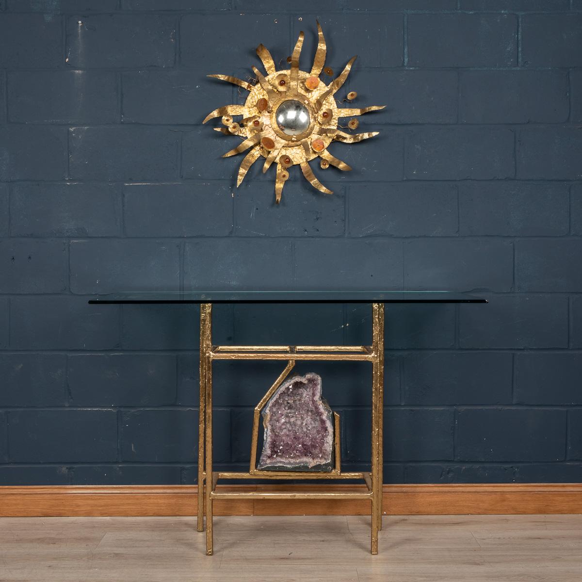 A spectacular console table designed and manufactured by Henri Fernandez in the 1970s, this item is largely made from brass encasing an amethyst geode. Amethysts are reported to open a person's third eye, considered to be a source of power and