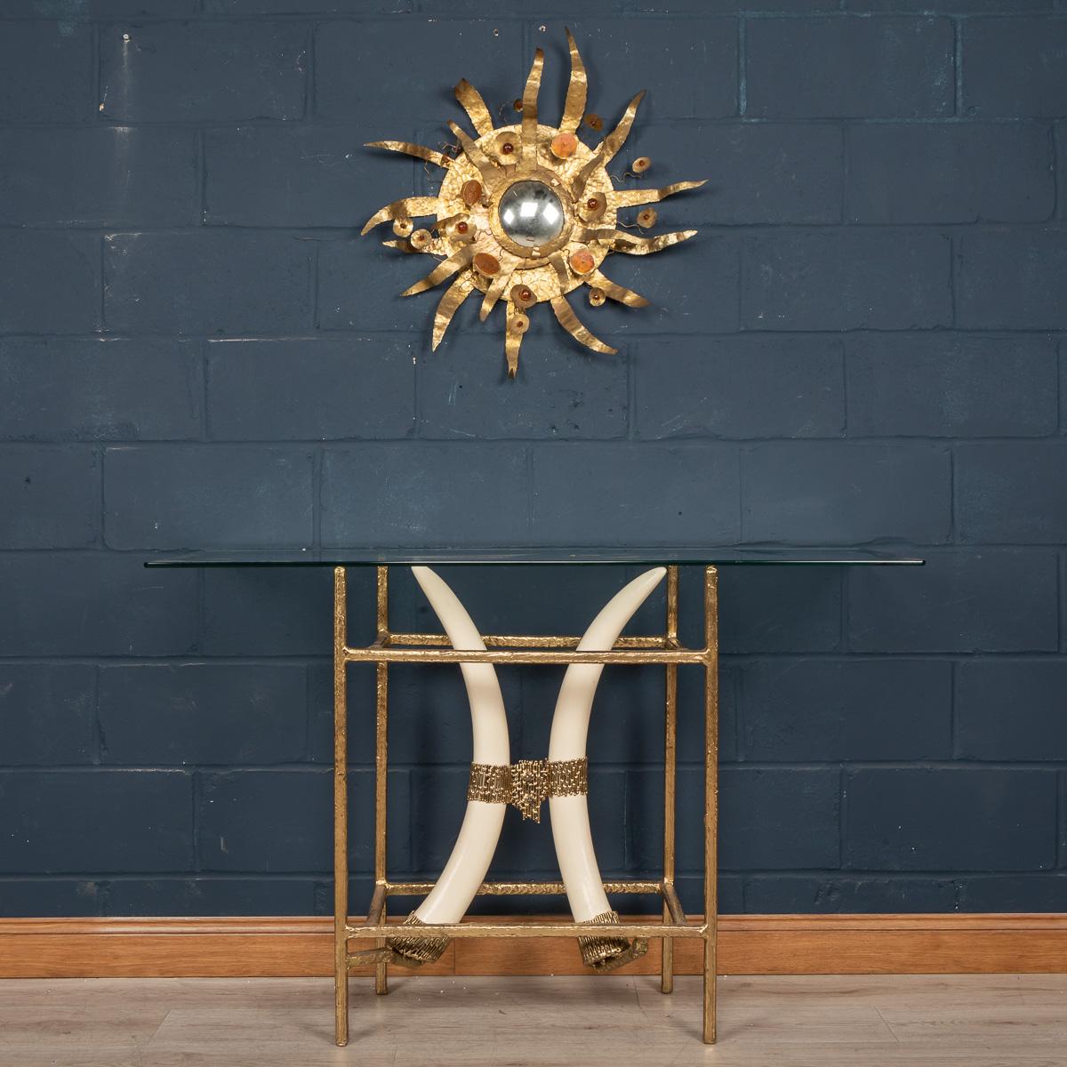 A spectacular console table designed and manufactured by Henri Fernandez in the 1970s, this item is largely made from brass two resin tusks. Certain to imbue your contemporary space with a touch of extravagance, this side table feels decidedly of