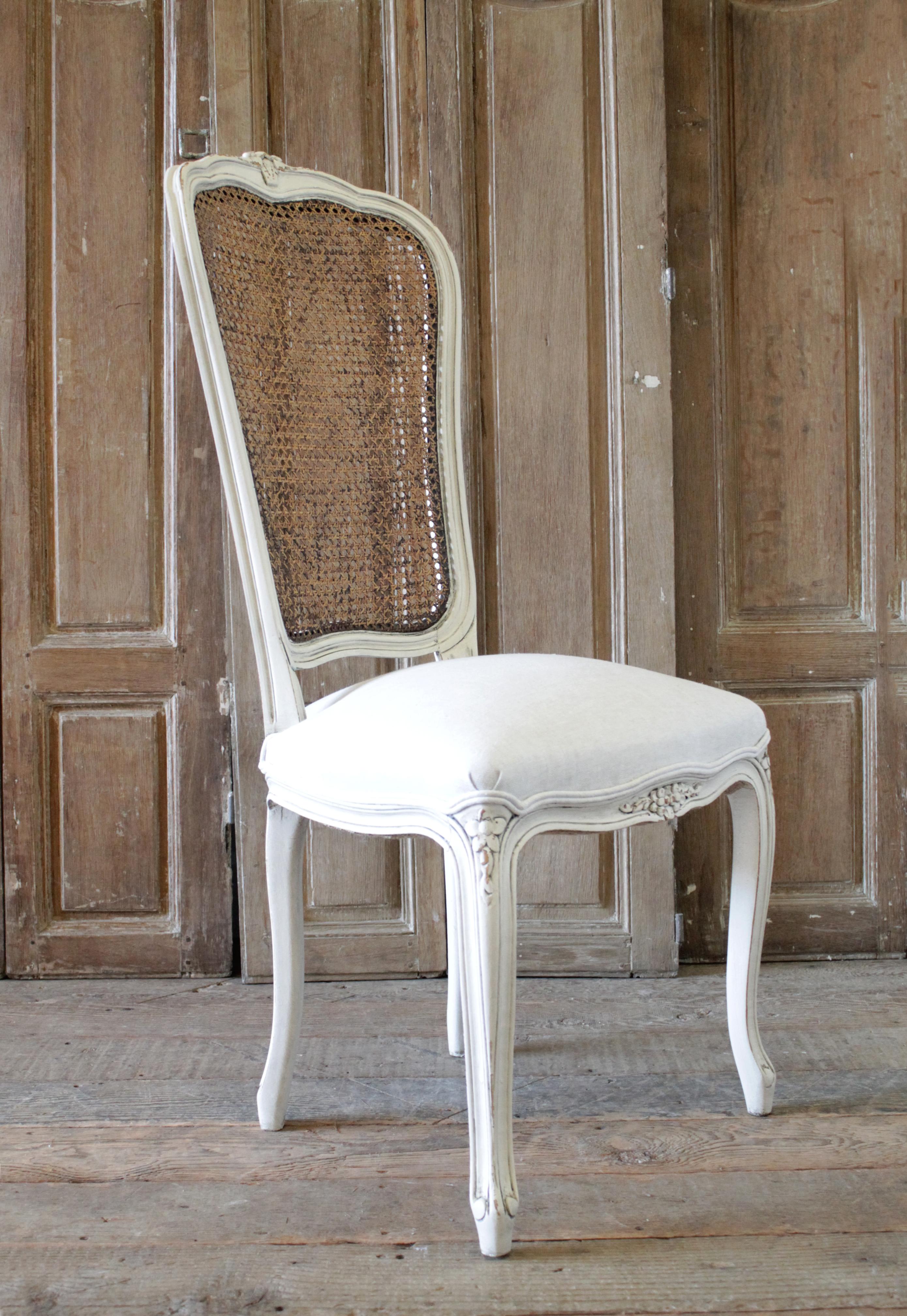 20th century French Country style cane back accent chair. Beautiful painted chair in our oyster white finish, with subtle distressed edges, and finished with an antique glazed patina. Great for a vanity chair or desk chair. Greige colored natural