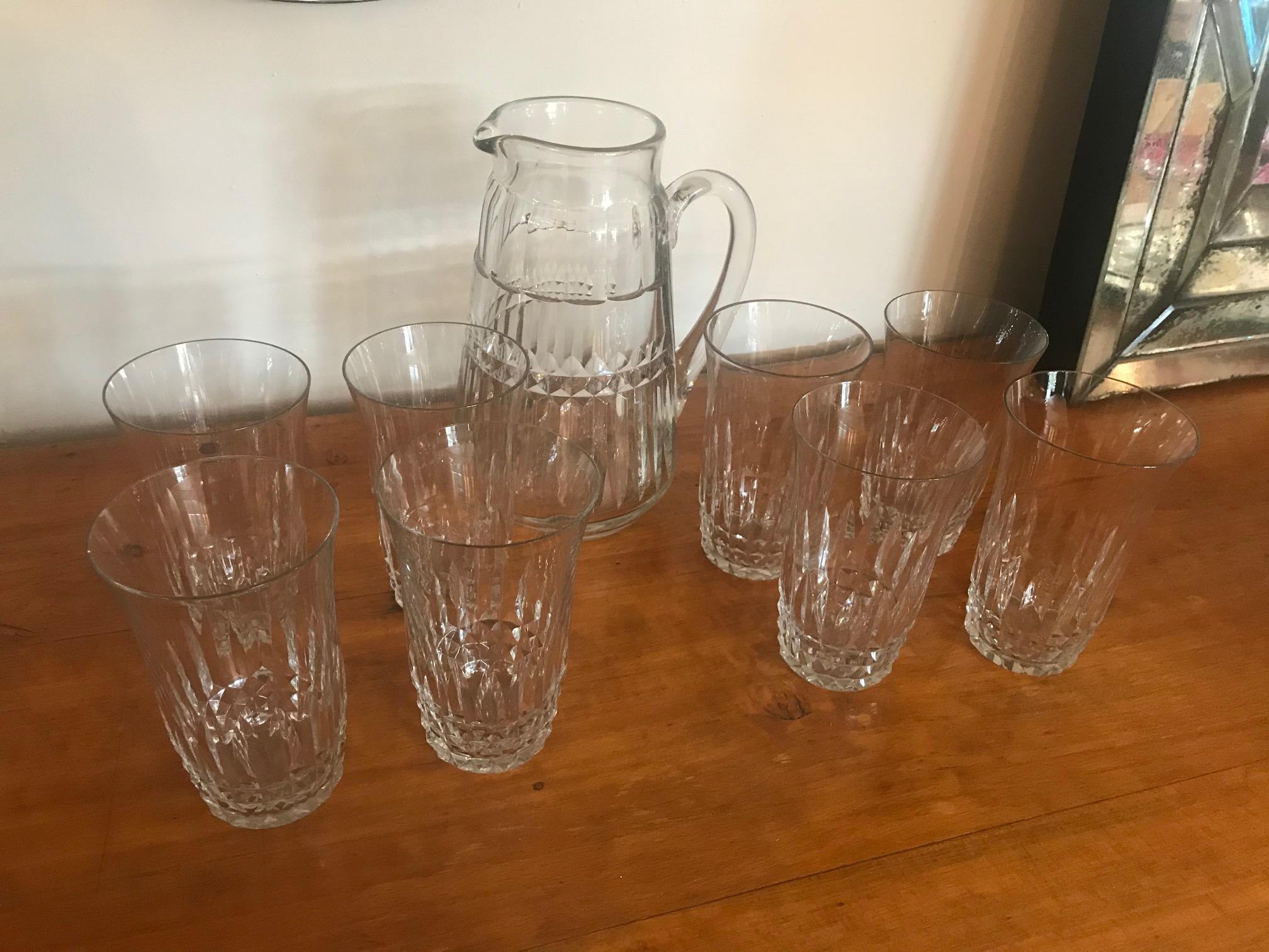 Very nice 20th century French crystal Baccarat set of a Carafe and 8 glasses from the 1940s. 
Flare shape of the glasses and nice engraved crystal work.
The carafe is also well designed. Very good condition.
 