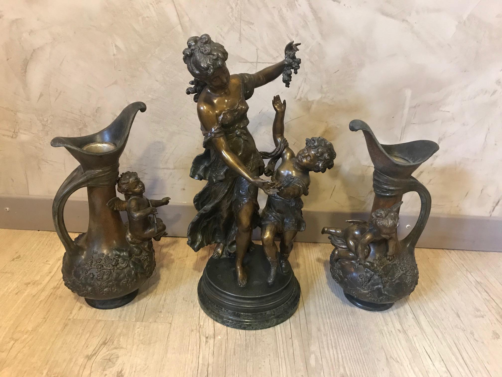 Very nice 20th century French Emile Bruchon Art Nouveau Spelter set of sculpture and two jars.
The large sculpture is representing a women with his children holding a grape in her hand on a marble base (there is a small damage on the marble