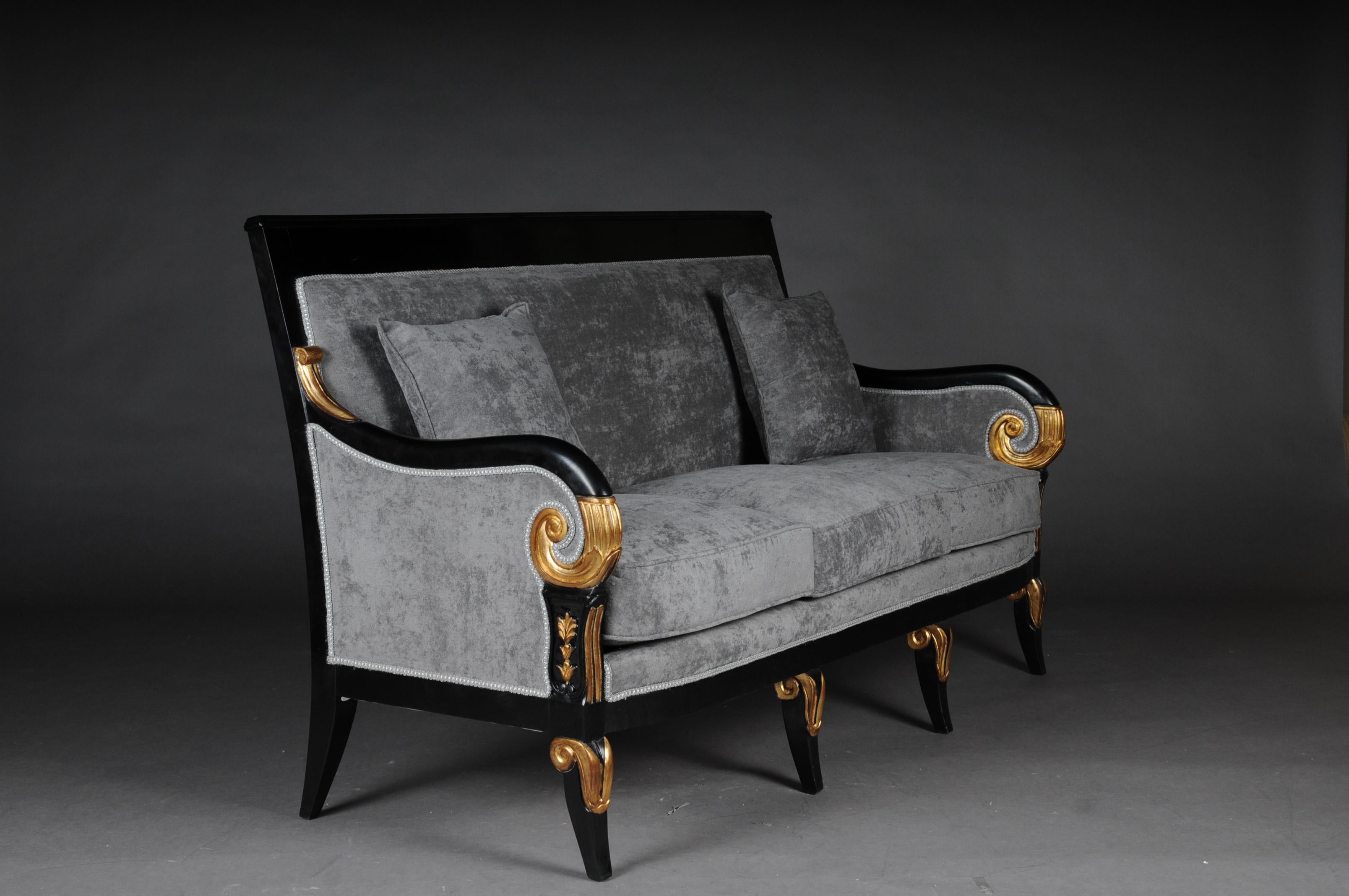 20th century French Empire Salon Sofa/Couch, black

Very specific finely detailed carving work on solid ebonized beechwood. Partially gilded. Cumbered bottom skirt on curved legs. Bowed arm rests for light ascending arms in rolled voluted endings.