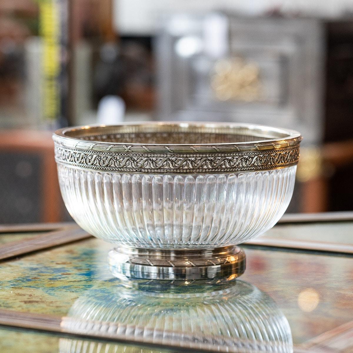 Antique early-20th century French Empire style solid silver large centerpiece bowl. The inverted fluted glass, mounted with a pierced silver rim and decorated with flowers, beads, ribbon tied, reeded boarders with x-junctions, standing on a flat