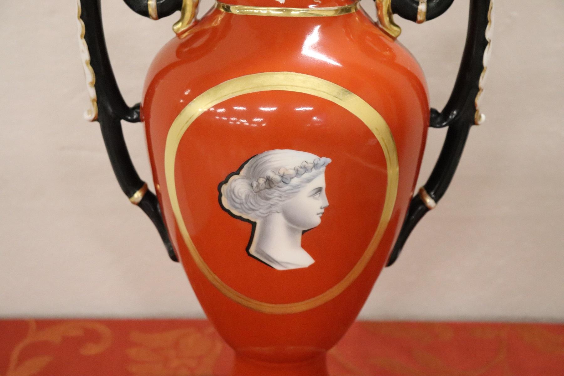 Beautiful ceramic vase in the shape of an amphora painted in shades of red with central portrait. Beautiful handles in black and gold. Perfect French style empire of classic style and taste. Ideal on a piece of furniture as a decoration for your