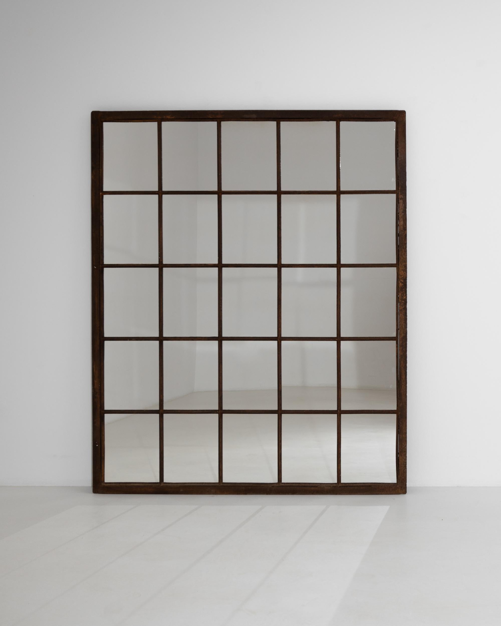 Originally used in a factory, the generous size and stripped back simplicity of this vintage mirror makes for a unique Industrial accent. Made in 20th century France, the grid-like form mimics a mullioned window, while the large proportions act to