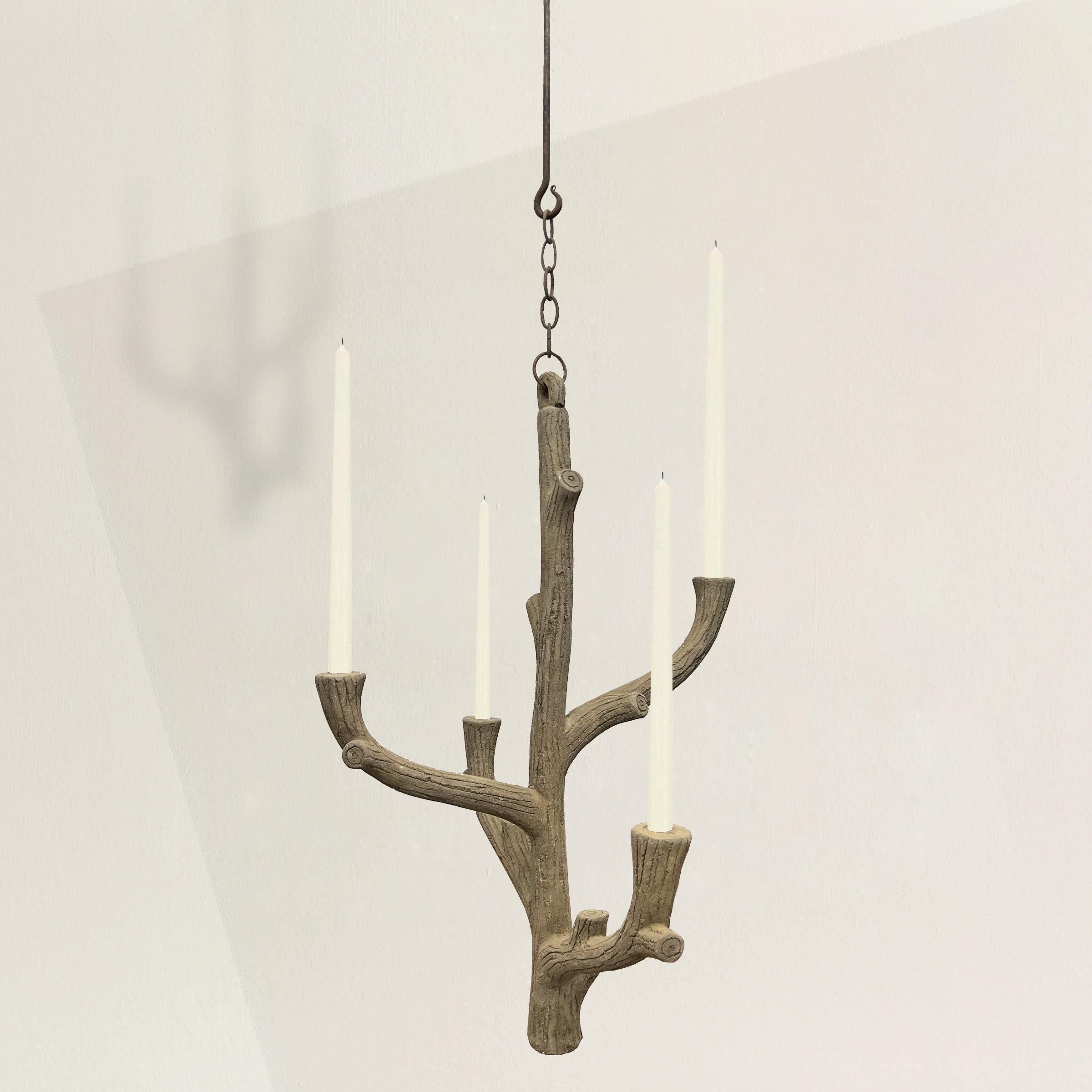 Behold this 20th-century French Faux Bois chandelier, a testament to the enduring charm of the Faux Bois movement. Crafted from cement, its four arms, artfully carved to mimic tree branches at varying heights, encapsulate the movement's dedication