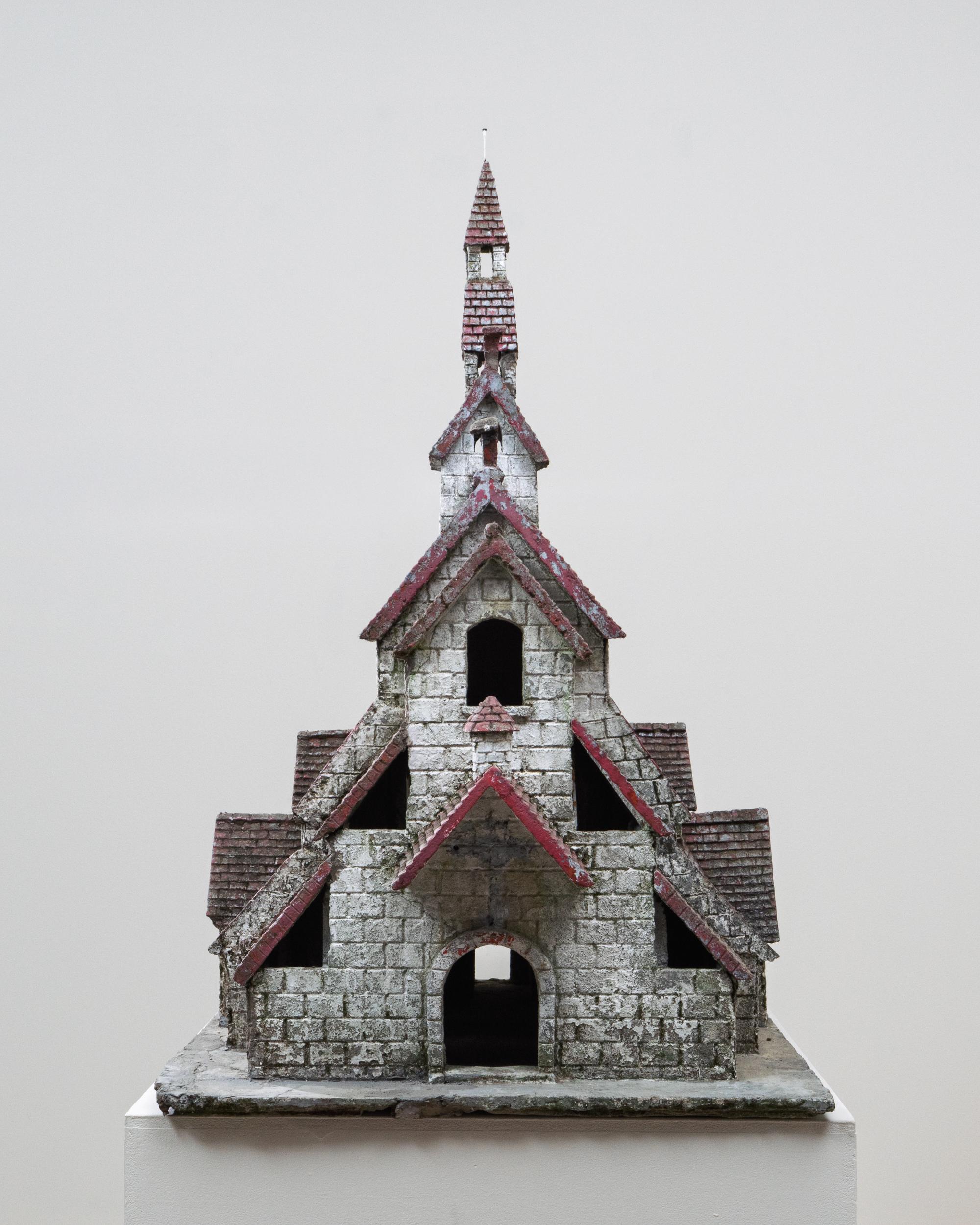 20th Century French Folk Art Concrete Model of Church. This remarkable folk art model, crafted in concrete during the 20th century, depicts a multi-tiered French church with charmingly naïve architectural detail. The structure features layered