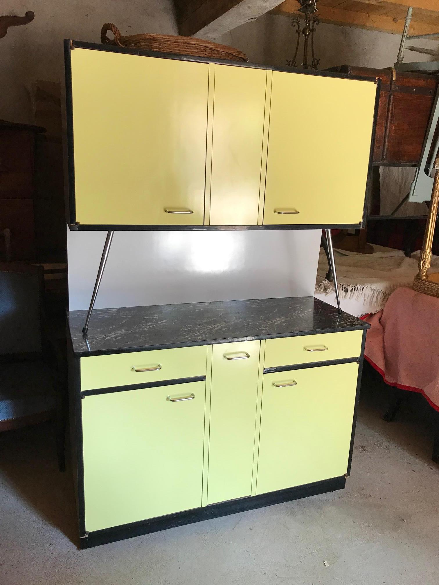 Very nice 20th century French yellow and black formica kitchen buffet from the 1970s.
Two parts attached at the back. The top is made with a black imitation marble.
Lot of drawers. In the middle the is a bread drawer. Very good condition.
True