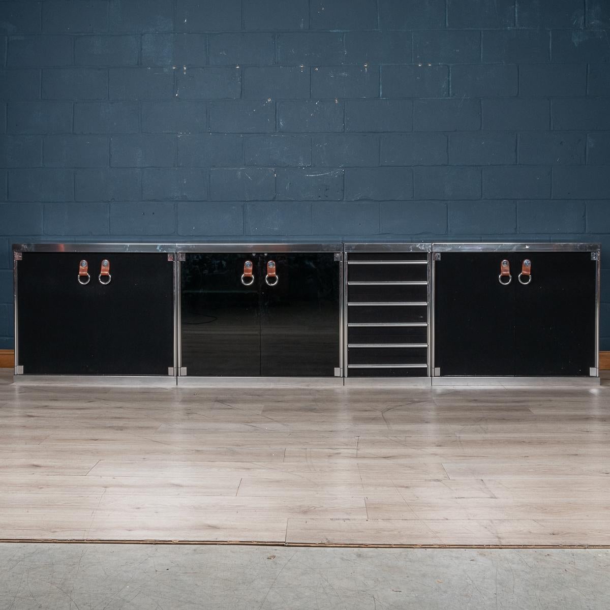 A superb four-piece sideboard consisting of three cabinets (one of which with dark smoked glass doors) and one bank of drawers designed by Guido Faleschini for Hermes, France, circa 1970. Hermes barely needs any introduction: it is probably the most