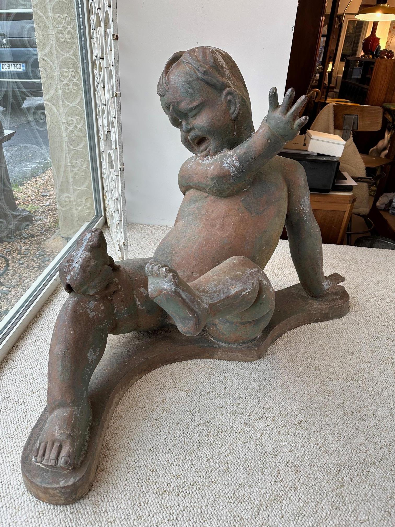 Beautiful 20th century metal cherub being frightened by a frog on his leg. 
Used to be close to a fountain as a garden ornament.
Very heavy. Ideal in a garden. 