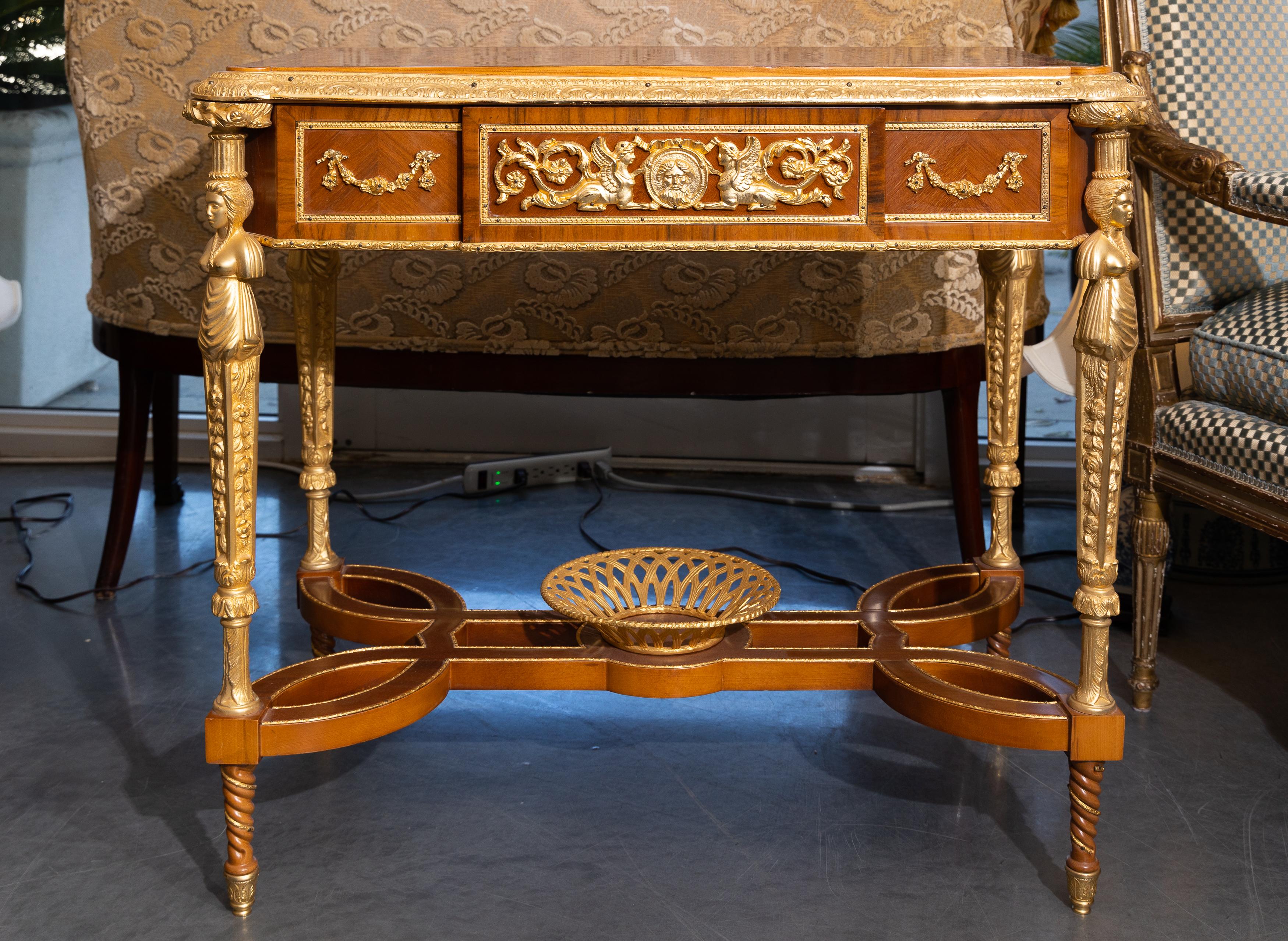 This is a nicely inlaid gilt bronze marquetry table after the model of Adam Weisweller. Wonderful proportions and offers a multitude of uses from a sofa table, center table of writing desk. High style and sophisticated.