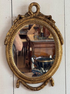 20th Century French Gilt Oval Mirror With Ribbon Crest