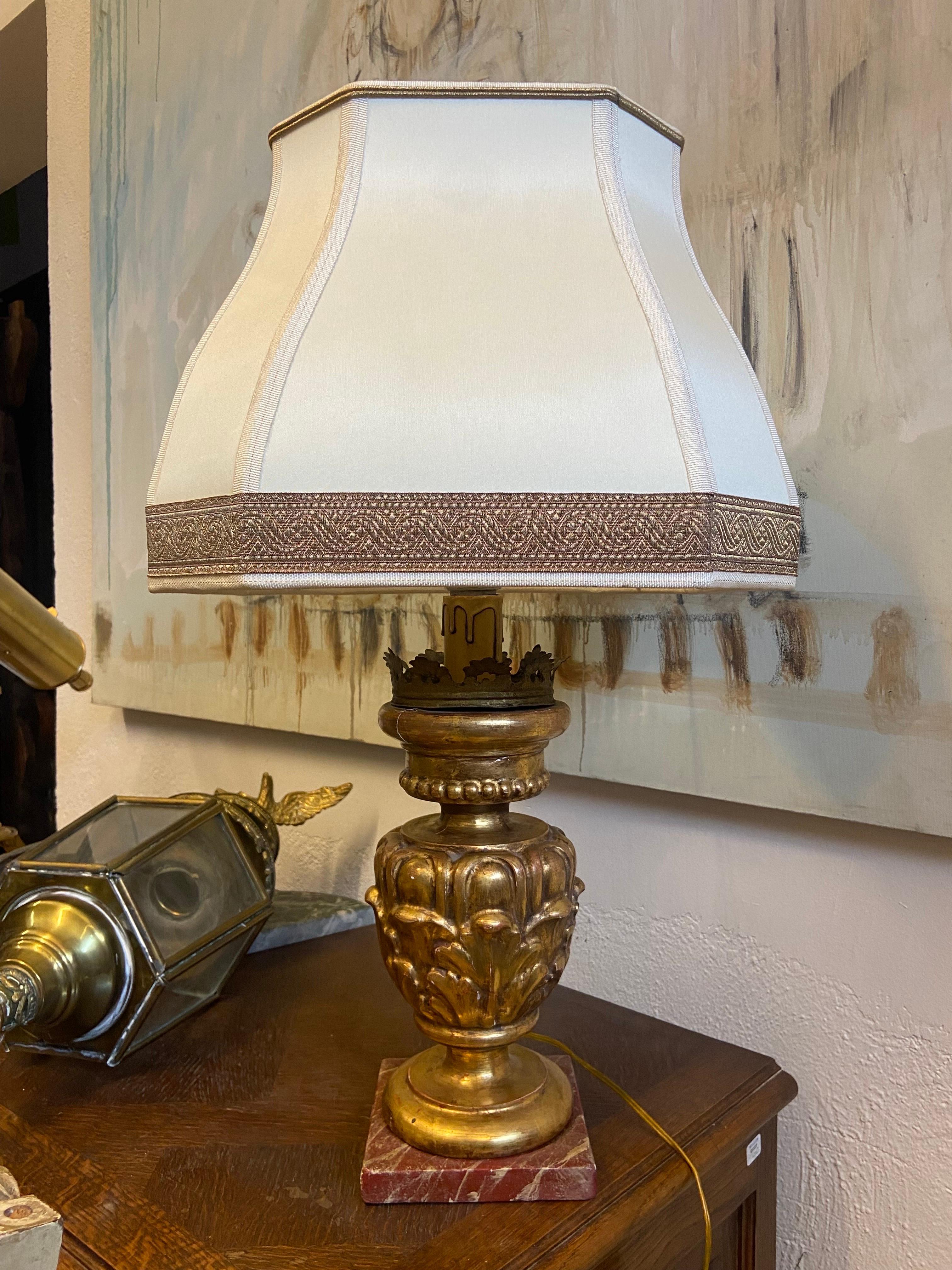 French table lamp standing on gilt wood hand carved base with wooden red marble imitation at the bottom. Lovely floral carved decoration and very elegant shape especially of the shade. Very good authentic condition with no restorations made so