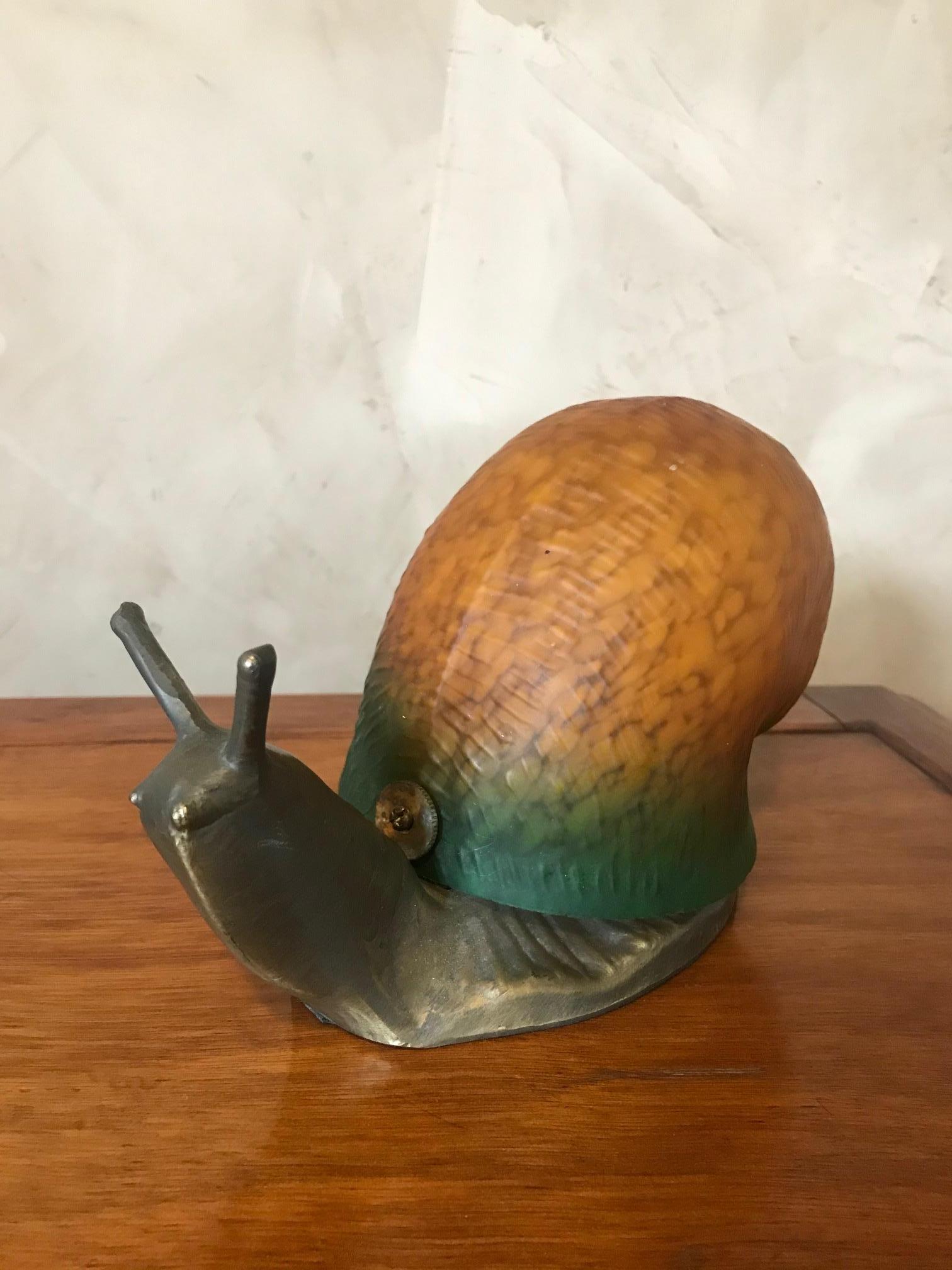 Very original 20th century French glass and metal snail table lamp from the 1980s. 
Orange and green glass. The glass is removable to change the bulb. 
Very nice quality.