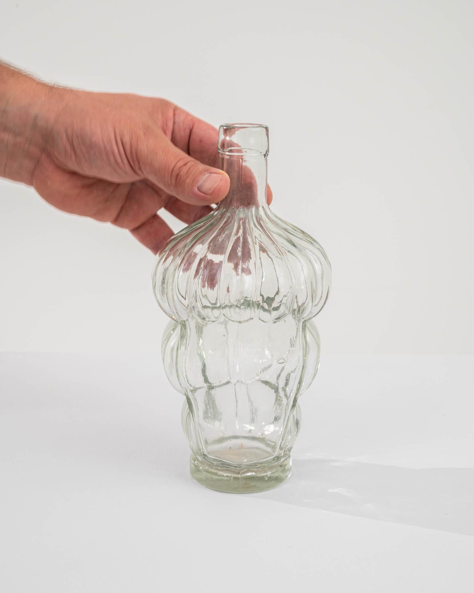 Indulge in the allure of vintage elegance with this 20th-century French glass bottle, featuring a distinctive bubble design. The bottle's enchanting silhouette showcases three tiers of humps, creating a visually captivating and curvaceous form. This
