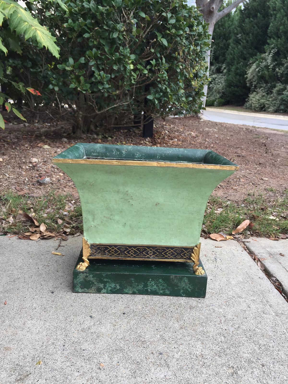 20th century French green tole cachepot with paw feet, painted black and gold band with gilt trim. Beautiful green finish with marbleized base and rim.