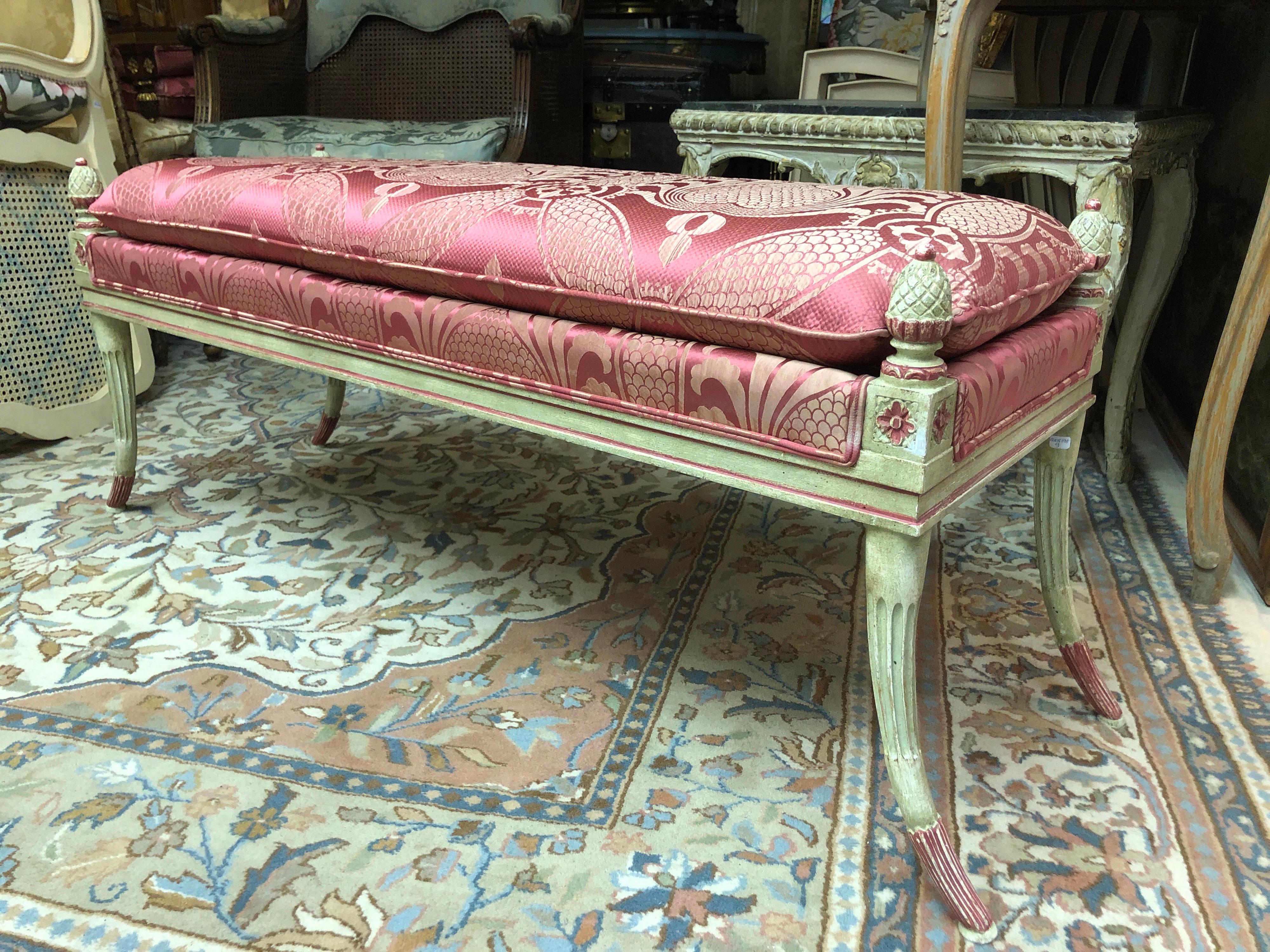 French bench in carved, molded and painted wood. It rests on four curved and rudent legs, terminated by pine cones. The piece is upholstered in rose silk textile. Very comfortable and stable structure.
France, circa 1920.
Measures: 40 x 115 x 40cm.