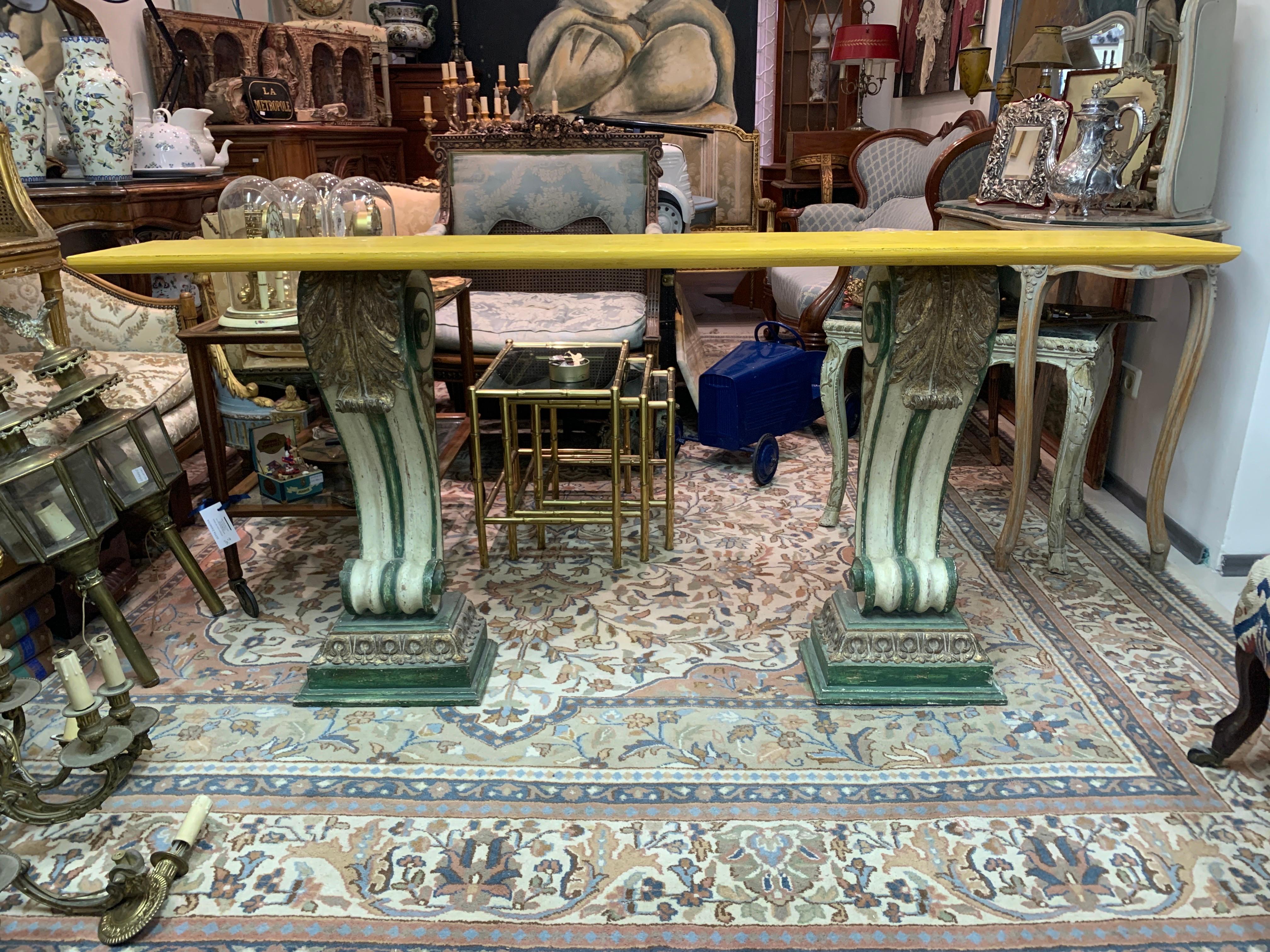 French console in carved and molded wood painted in polychrome. Rolling pilaster base supporting an amazing beige-yellow marble top.
Very good condition, circa 1970.