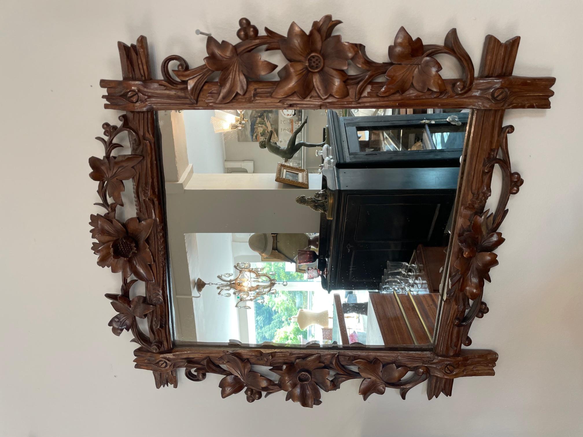 Very nice and original 20th century French hand sculpted walnut mirror from 1920s. 
Flowers and leaves sculpted in the wood. 
Good quality. 
Fabric at the back. Unique piece, craftsmanship.
 