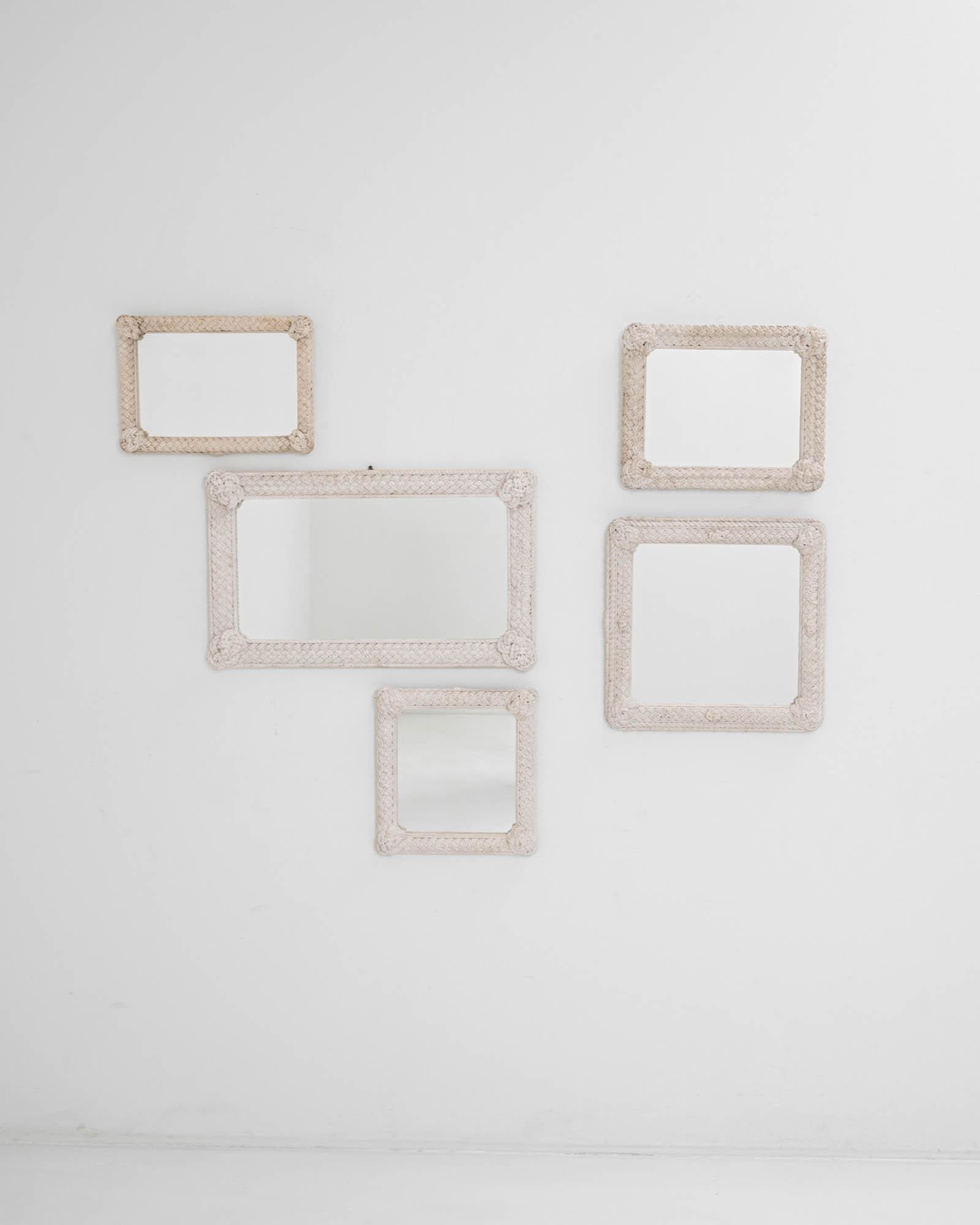 Rustic and whimsical, woven macrame frames give this set of five vintage mirrors a hand-crafted charm. Made in France in the 20th century, the lively variety of braiding techniques represents the ancient craft of rope work, the time-worn white