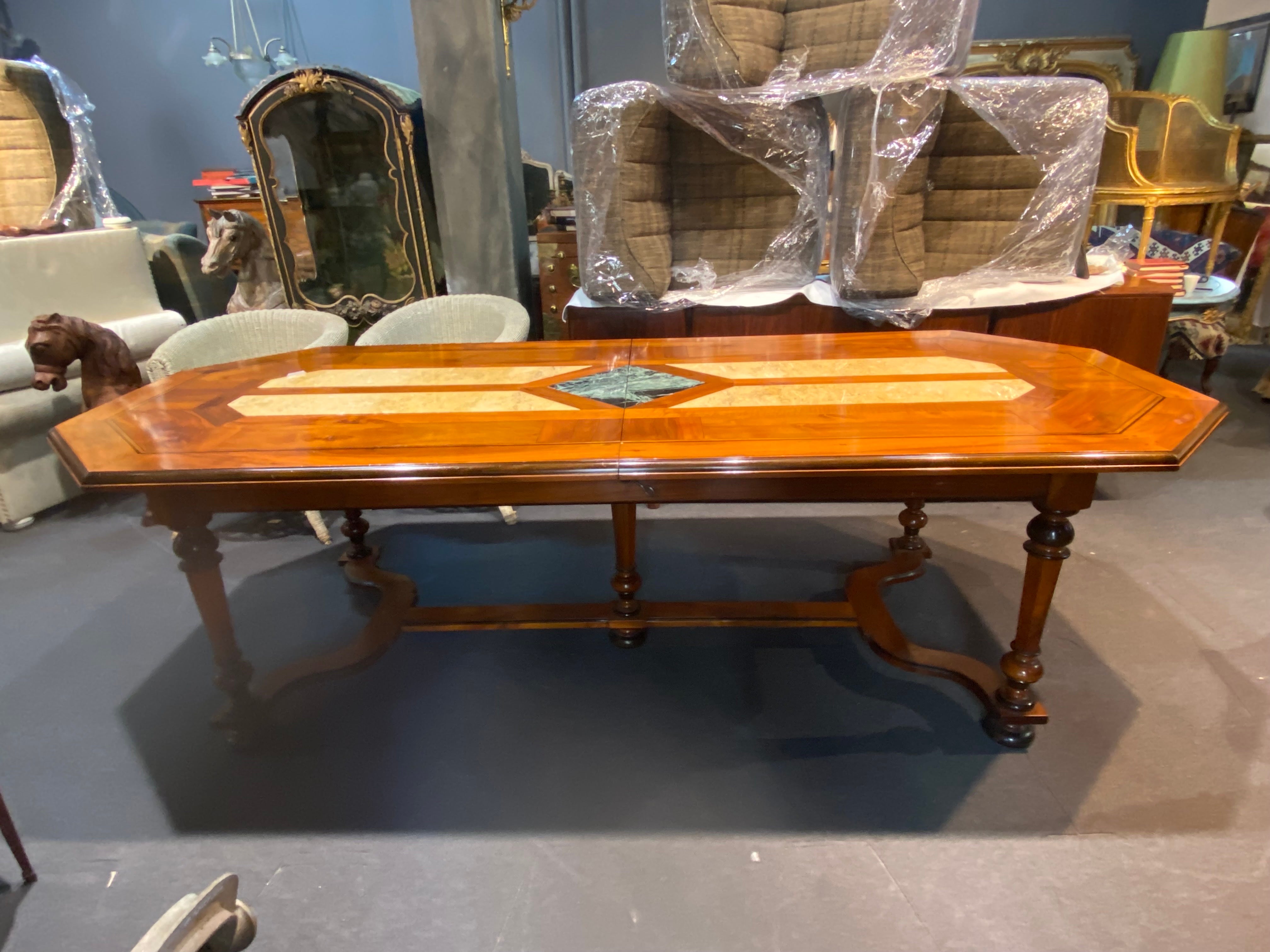 20th Century French large walnut extendable dining table with marble central decoration and two additional parts. The table could be extended from 270 cm to 320 cm and to 370 cm if both additional parts are placed in the centre.
France, circa