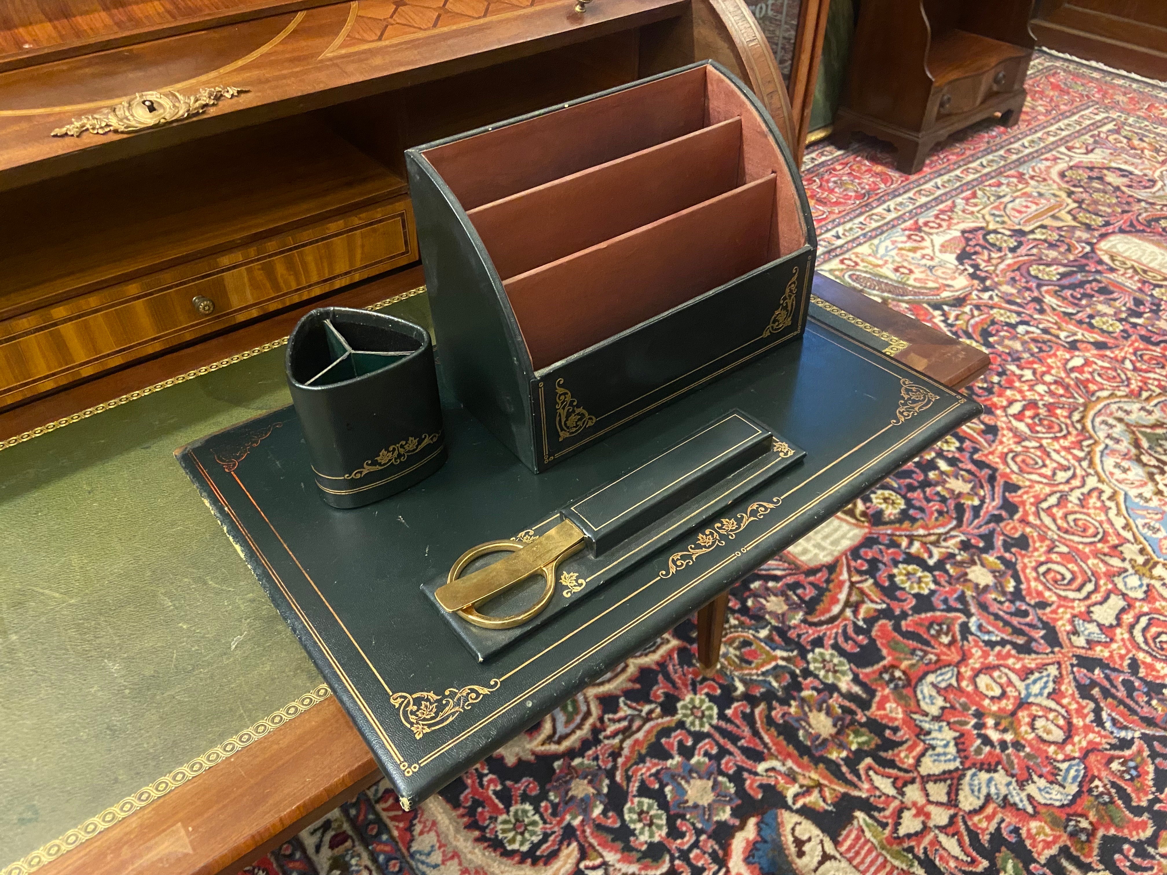 Great five piece French leather desk set by Le Tanneur. All pieces wrapped in very dark green leather. Desk set includes a desk pad which is a folder as well, pen holder, mail holder, scissors and letter opener. All pieces are in quite good