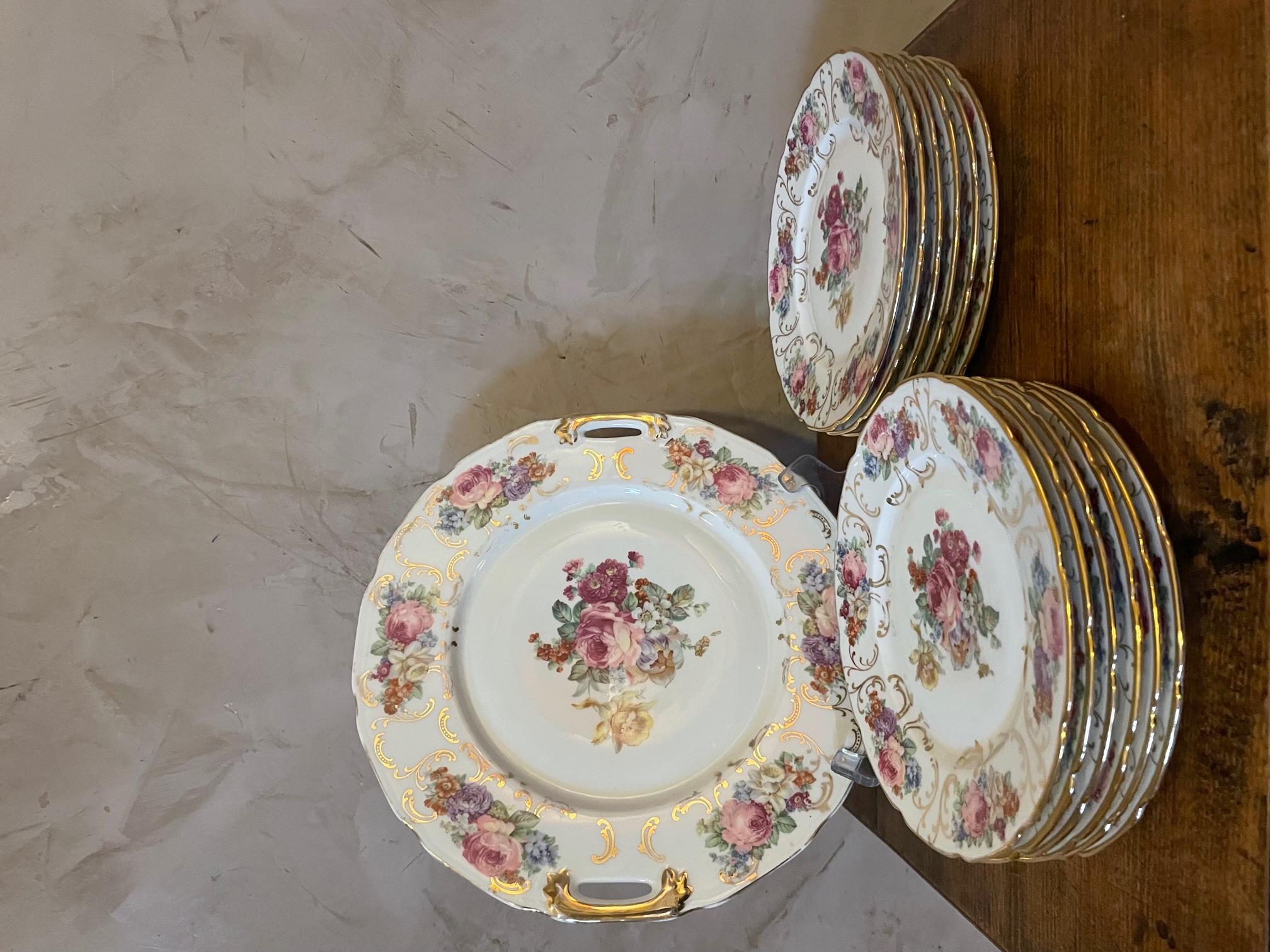 Beautiful set of 12 plates and a plater made in Limoges Porcelain (stamped LPN at the back). 
Flowers and golden net decoration. 
Good quality and condition.