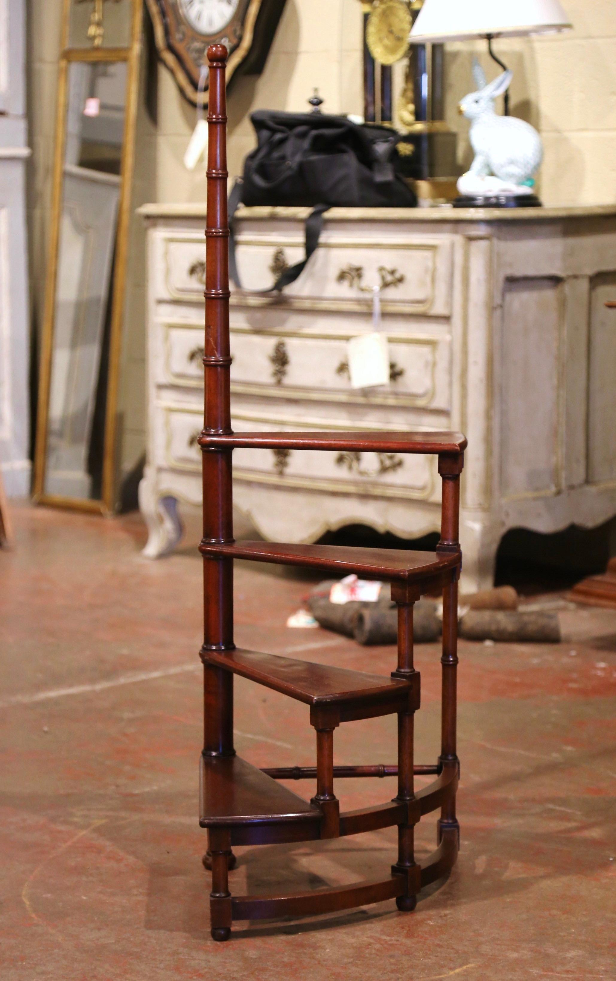Use this vintage fruitwood staircase to organize books in your office or library. Created in France circa 1980 and standing on turned legs, the small circular step ladder features four stairs roll around a turned, central post. Versatile and