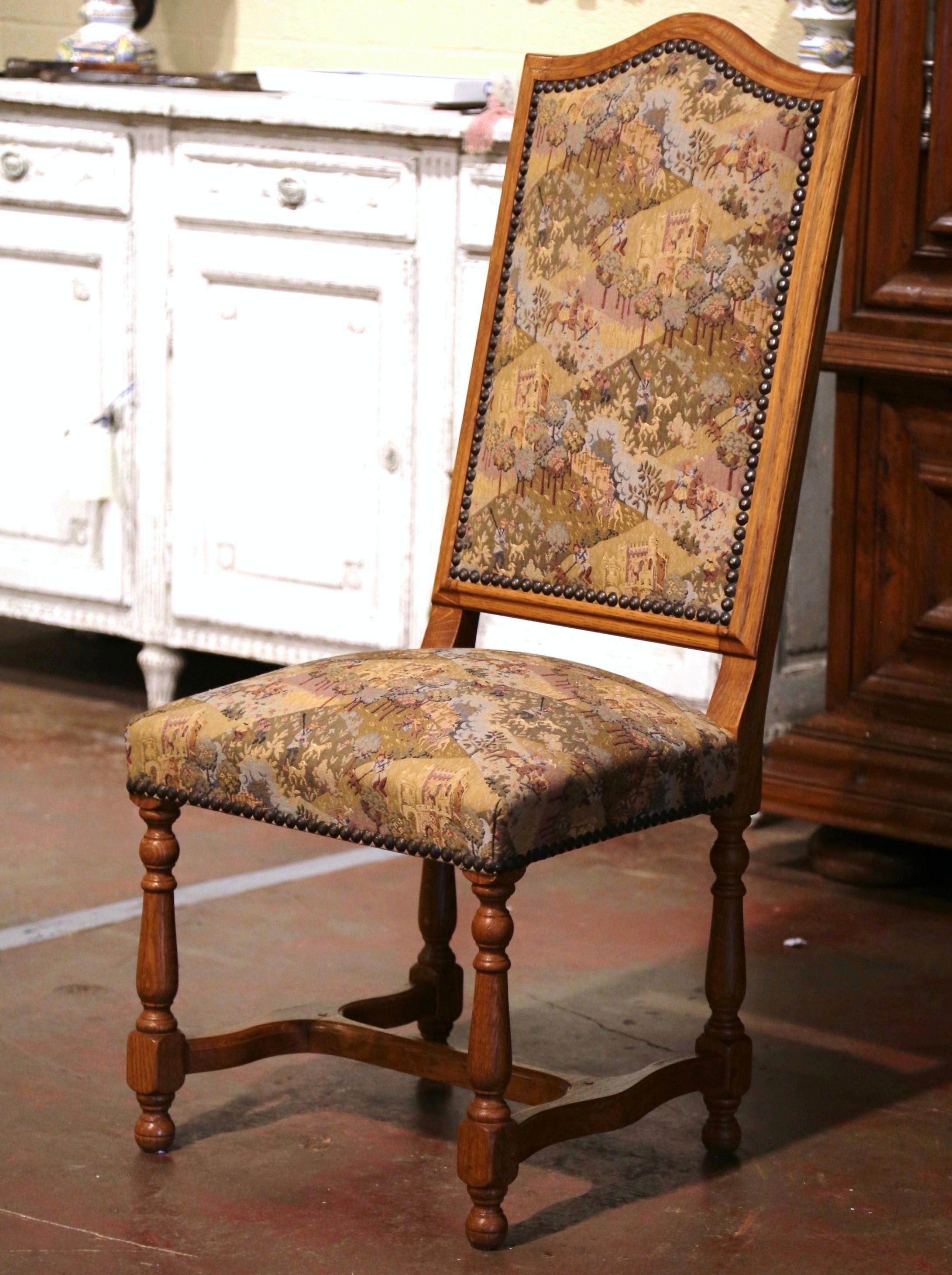 Dress a large dining table with this set of fourteen high back chairs; crafted in southern France circa 1980, each fruit wood chair sits on turned legs ending with bun feet, and connected with a bottom stretcher. Each chair features a tall pitched