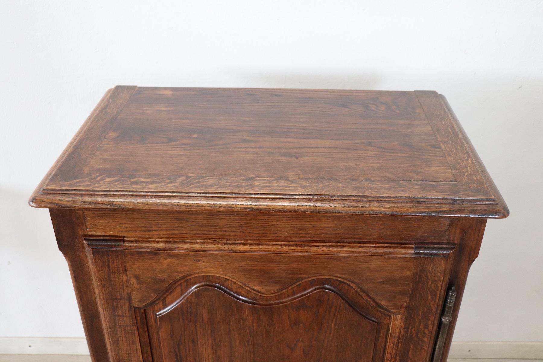Particular small sideboard or cabinet in solid oakwood. In perfect French Louis XIV style with wavy legs. On the front one door with internal two shelfs. The internal shelfs can be moved as desired. This furniture is used but in perfect condition